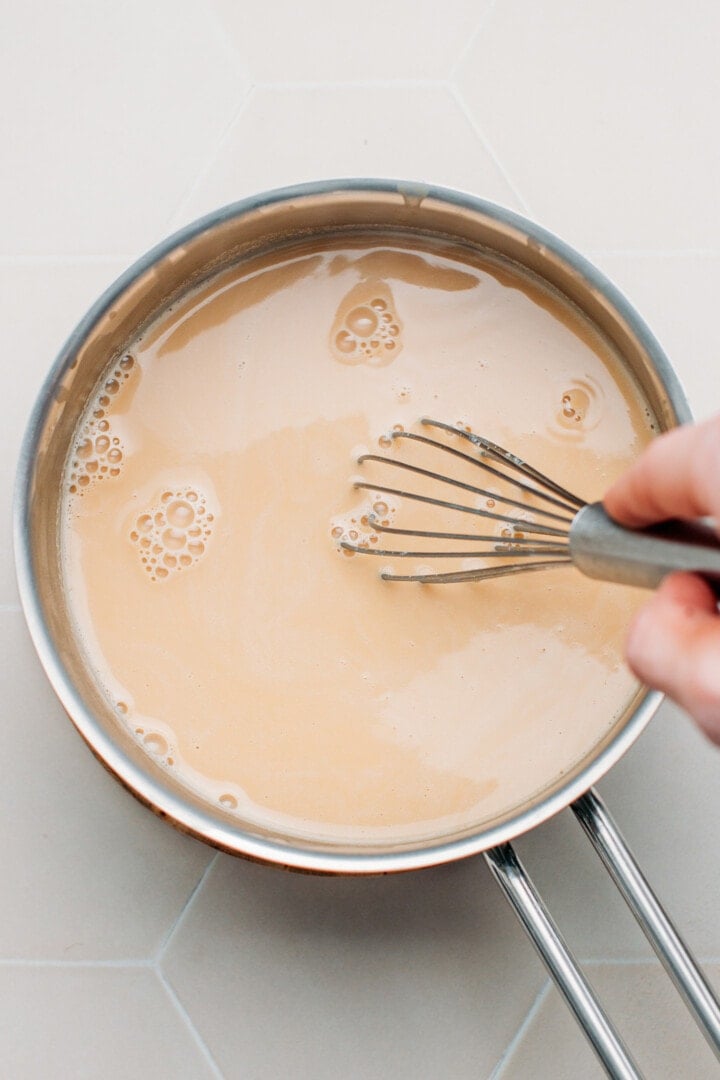 Cooking peanut milk in a saucepan.