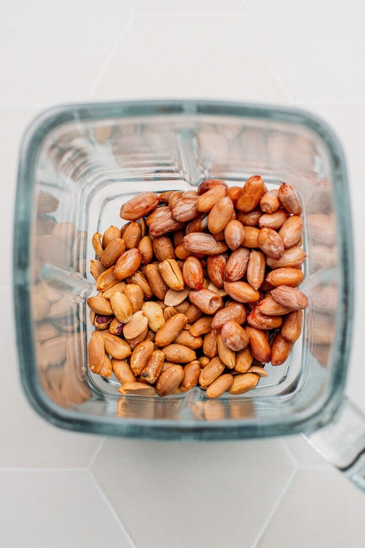 Raw and roasted peanuts in a blender.