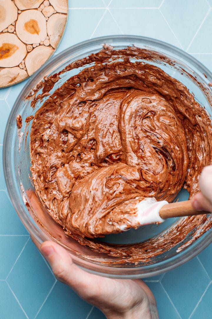 Folding melted chocolate with aquafaba.