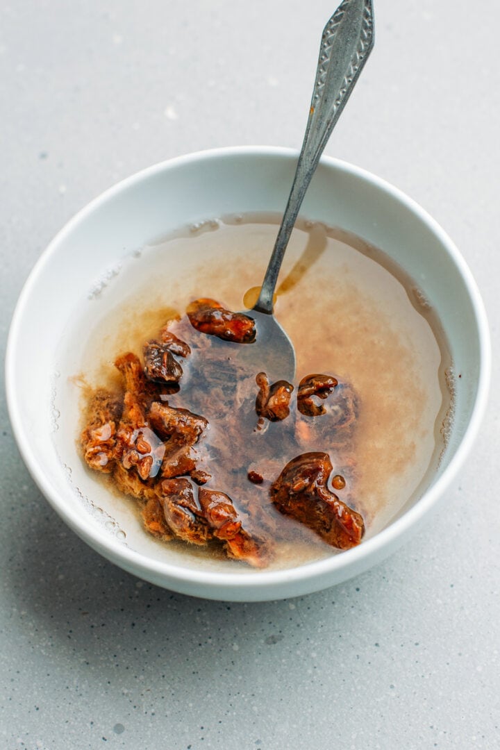 Tamarind pulp with water in a bowl.