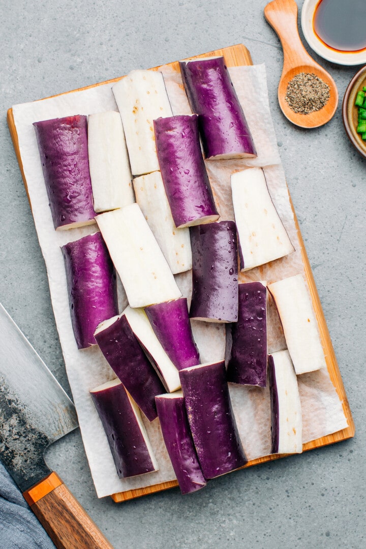 Sliced eggplant on a cutting board.