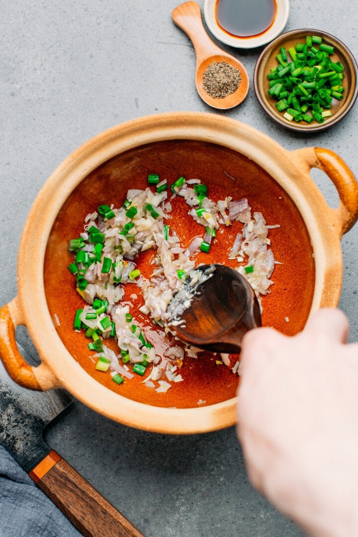 Sautéed garlic and shallots in a clay pot.