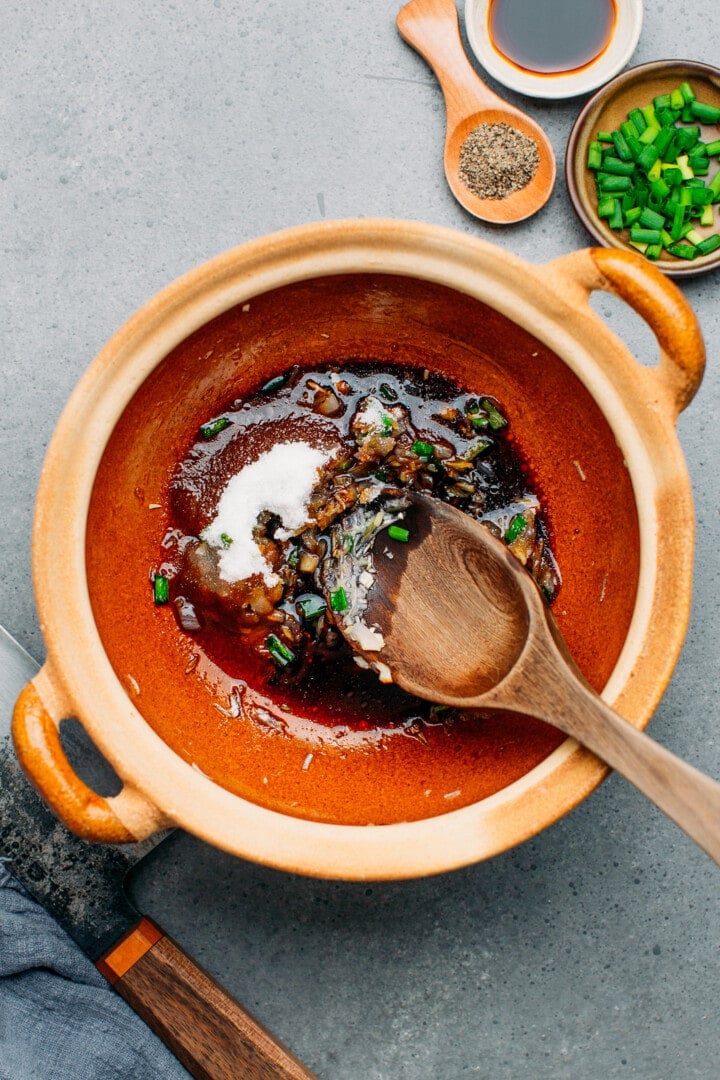 Garlic, sugar, and soy sauce in a clay pot.