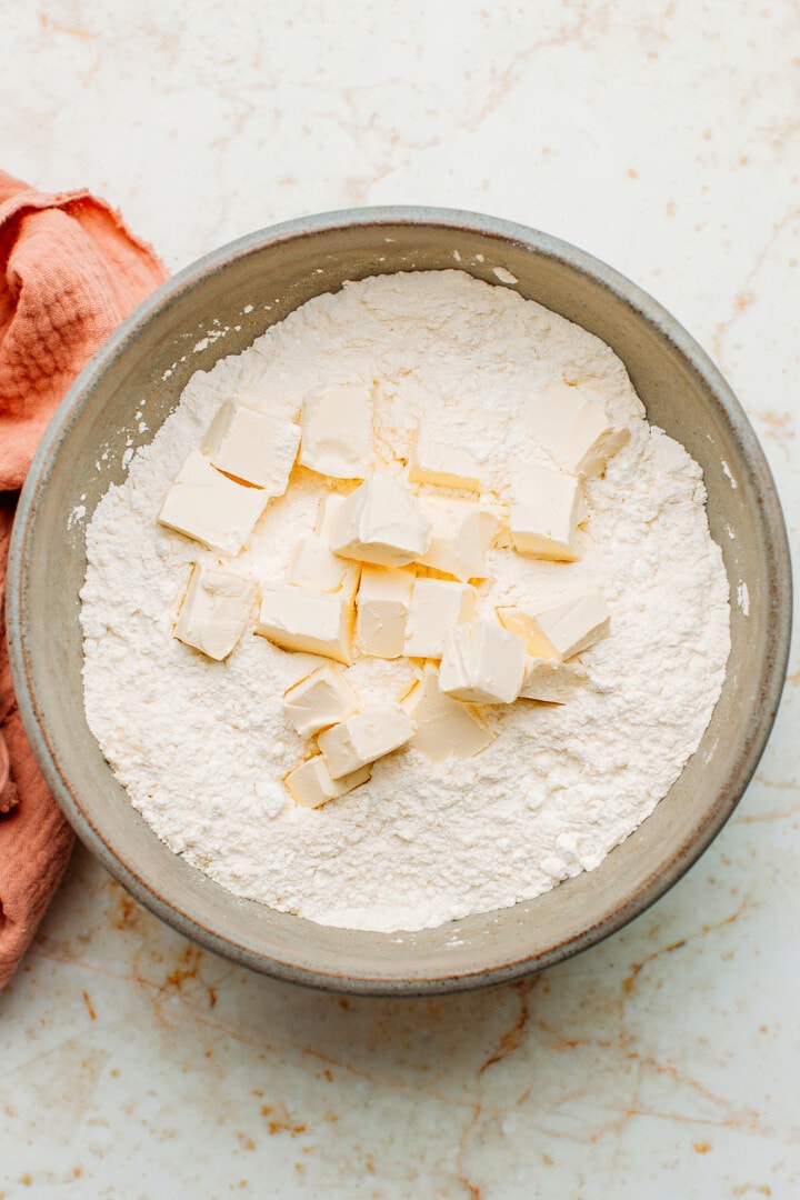 Diced butter with flower in a bowl.