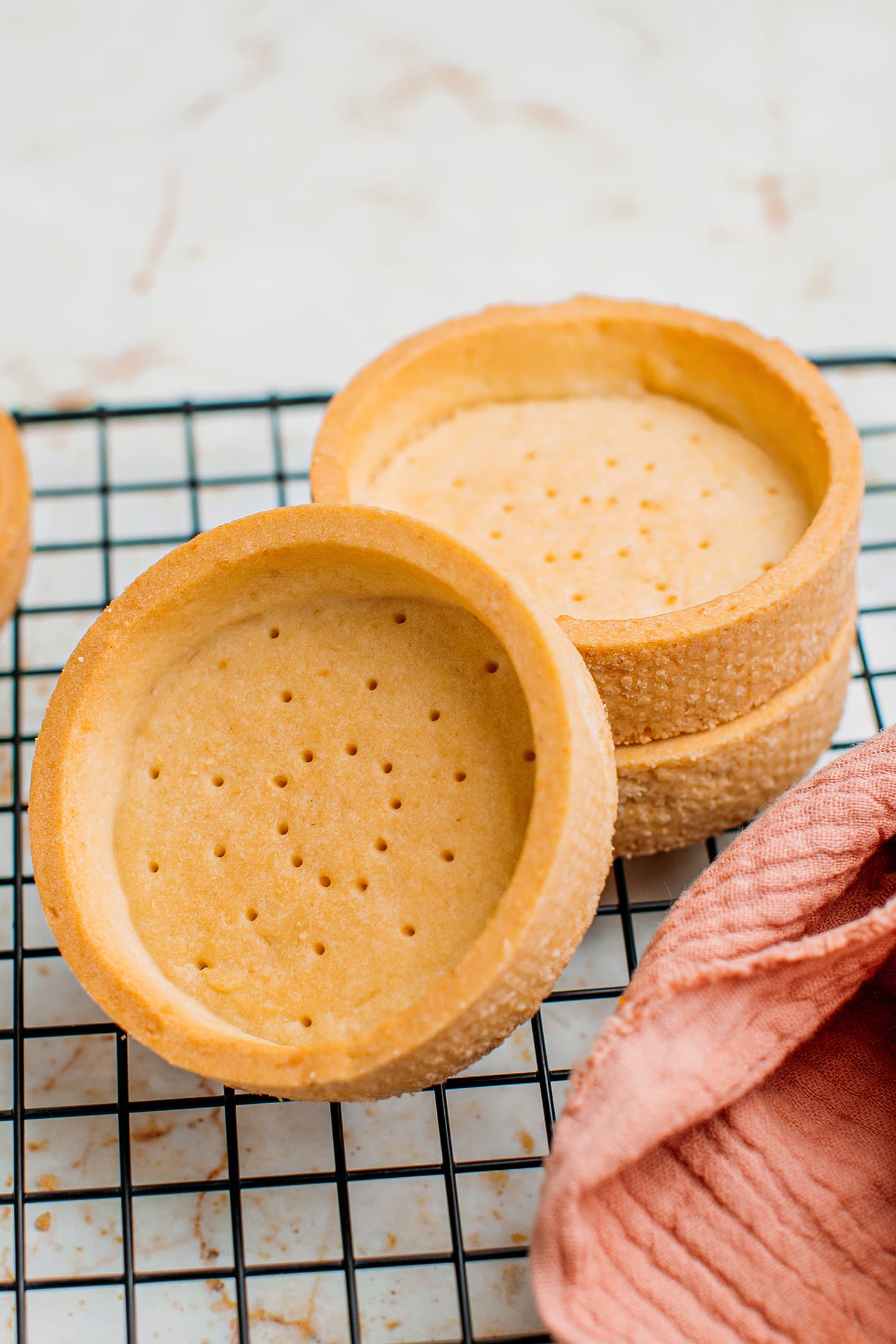 Tartlet shells on a cooling rack.