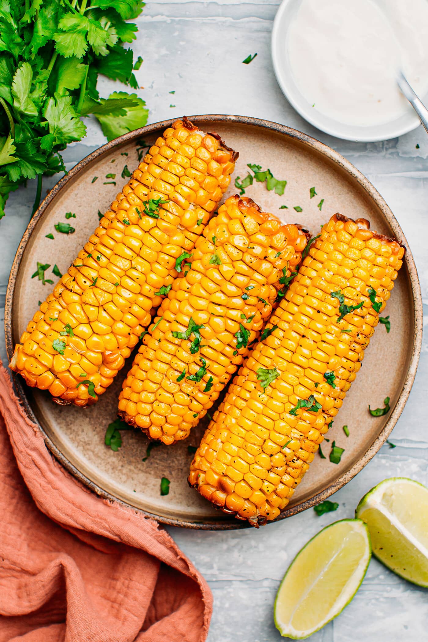 Three ears of corn on a plate.