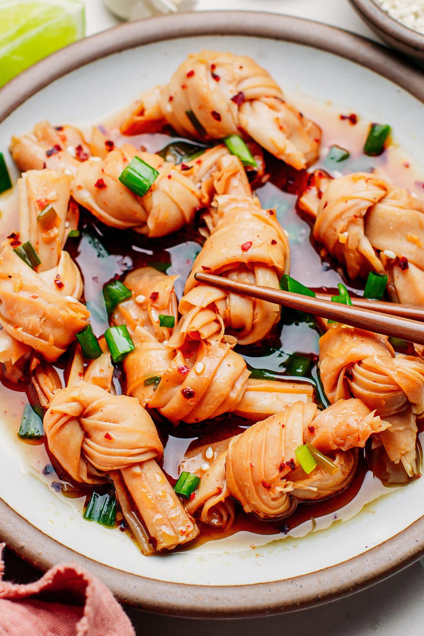 Close-up of bean curd knots in chili oil.