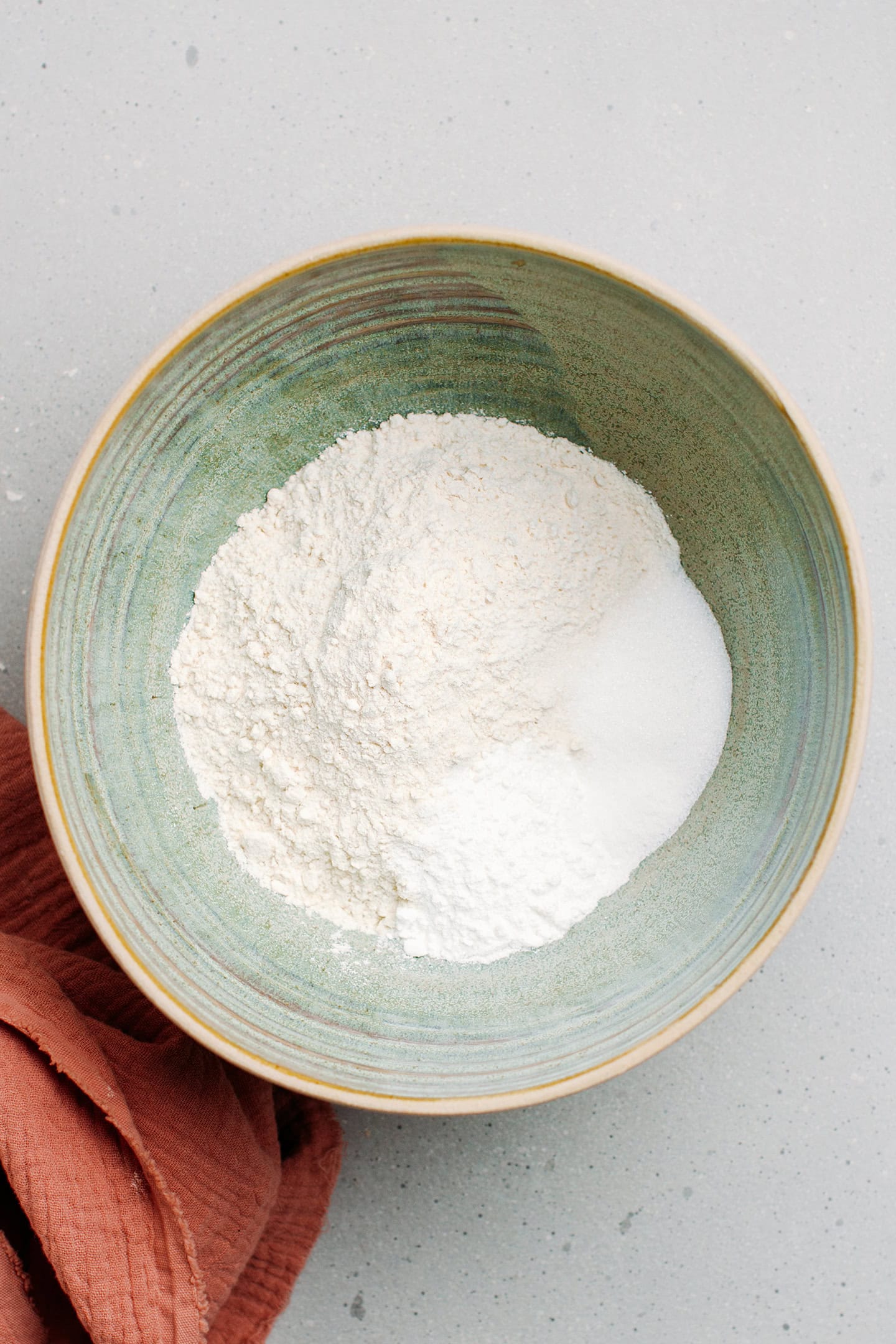 Flour, sugar, and baking powder in a mixing bowl.