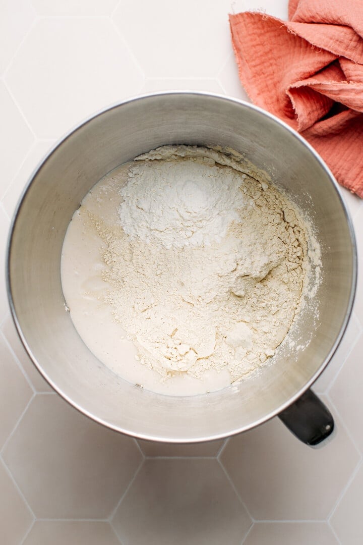 Tofu, vital wheat gluten, and flour in the bowl of a stand mixer.