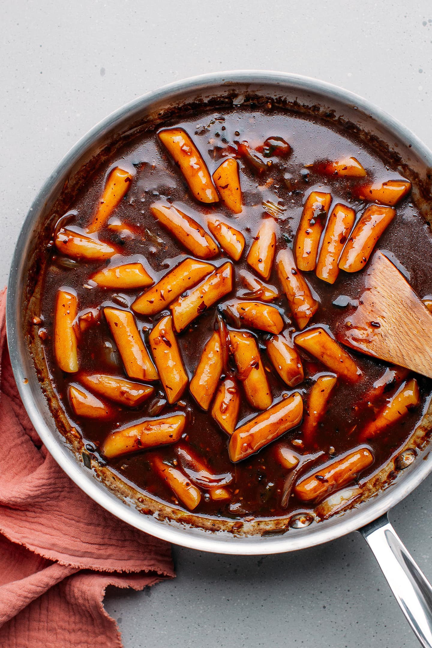 Cooked Tteokbokki with black bean sauce in a pan.