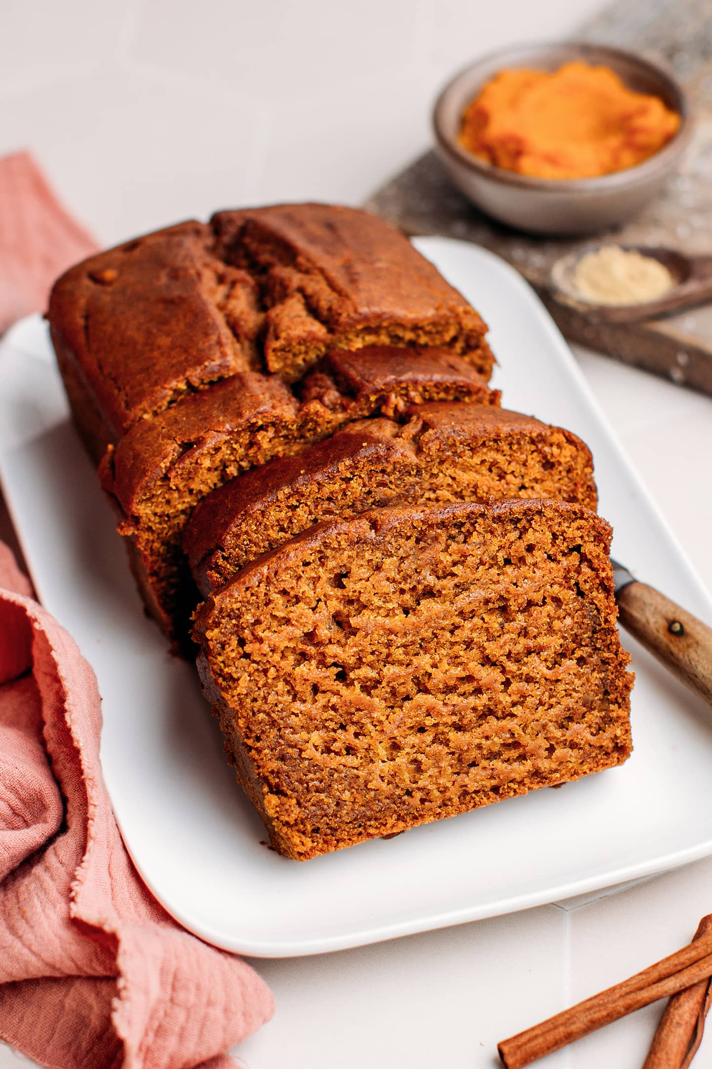 Sliced vegan pumpkin bread on a plate.