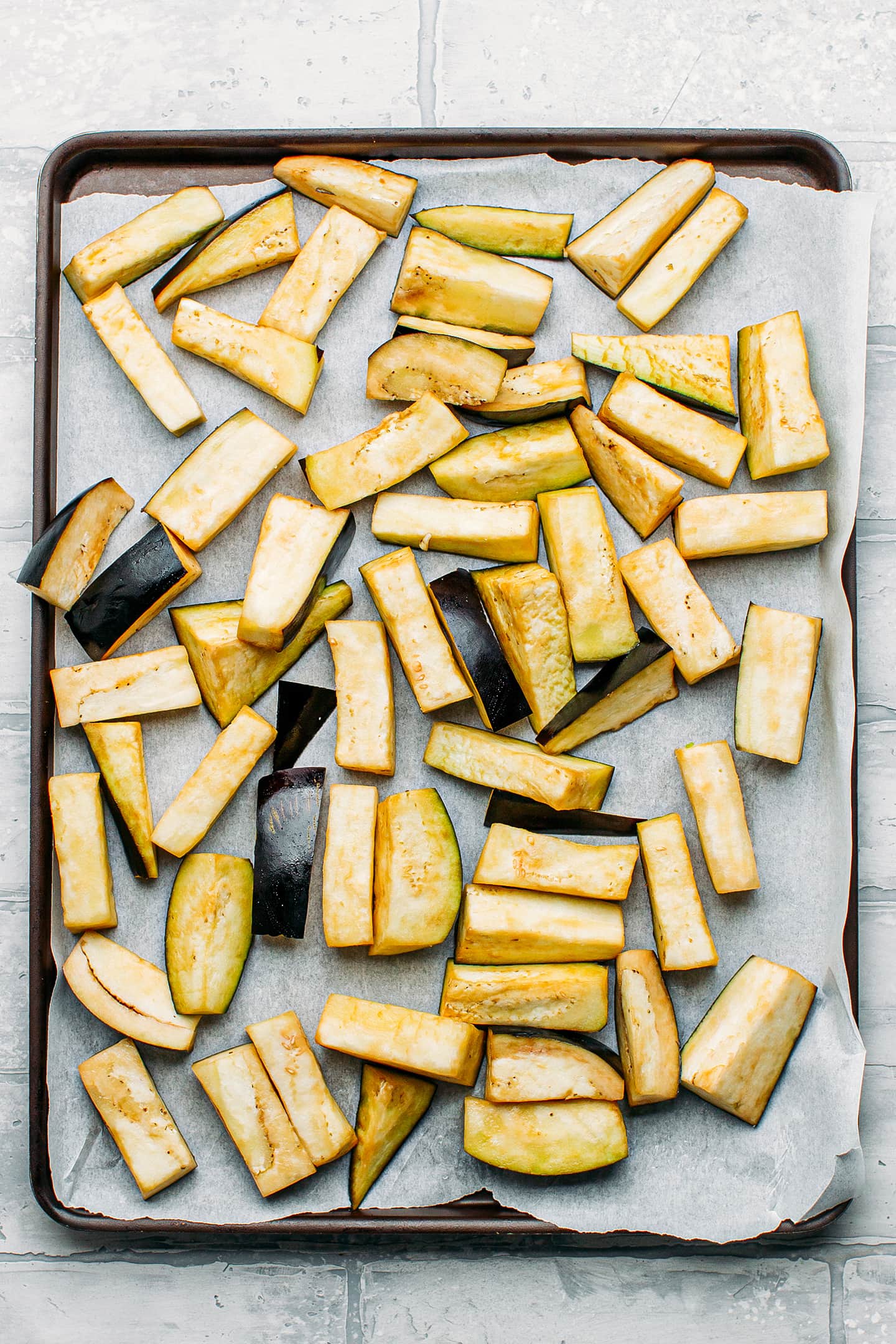 Sliced eggplants on a baking sheet.