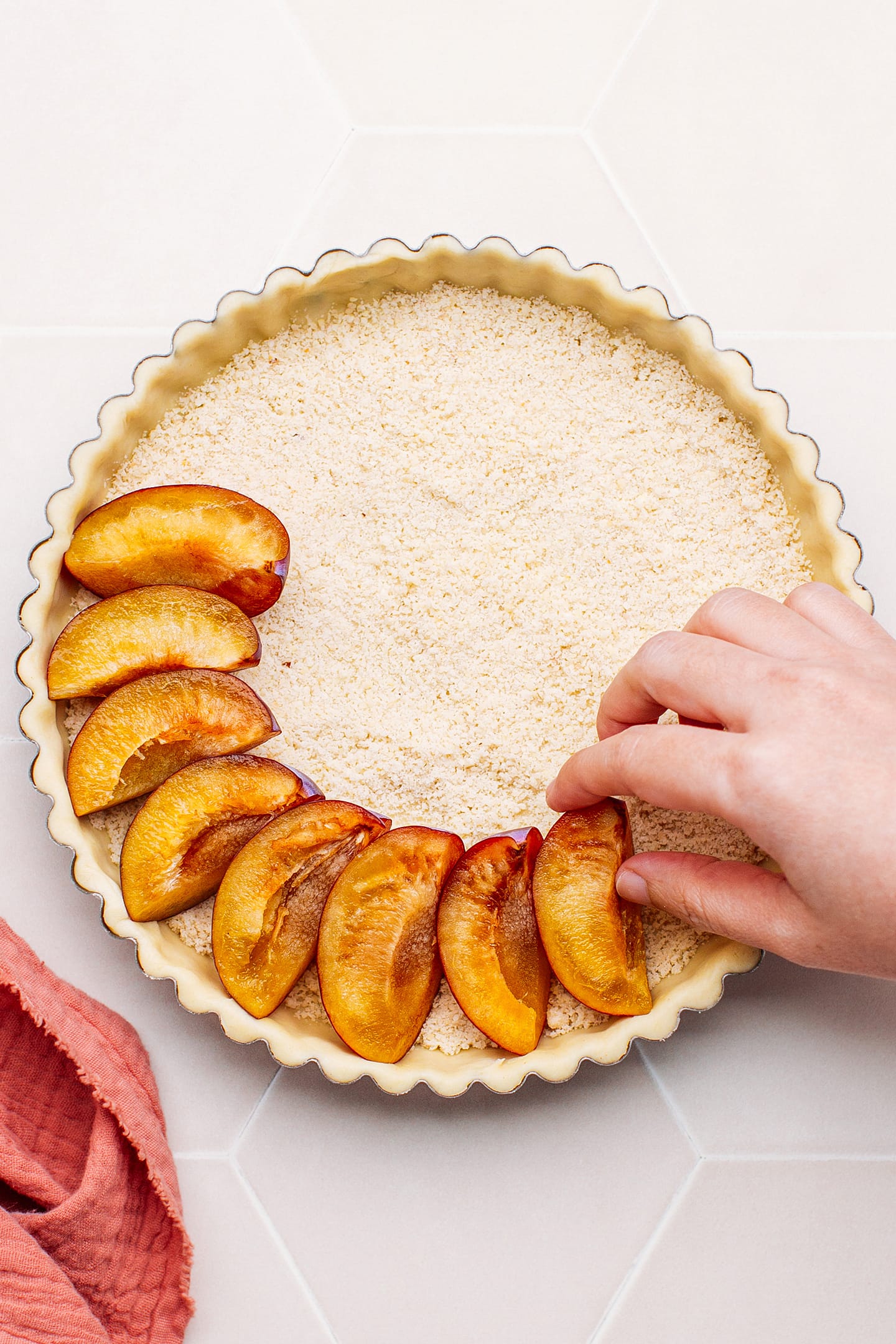 Placing quartered prunes into a pie crust.