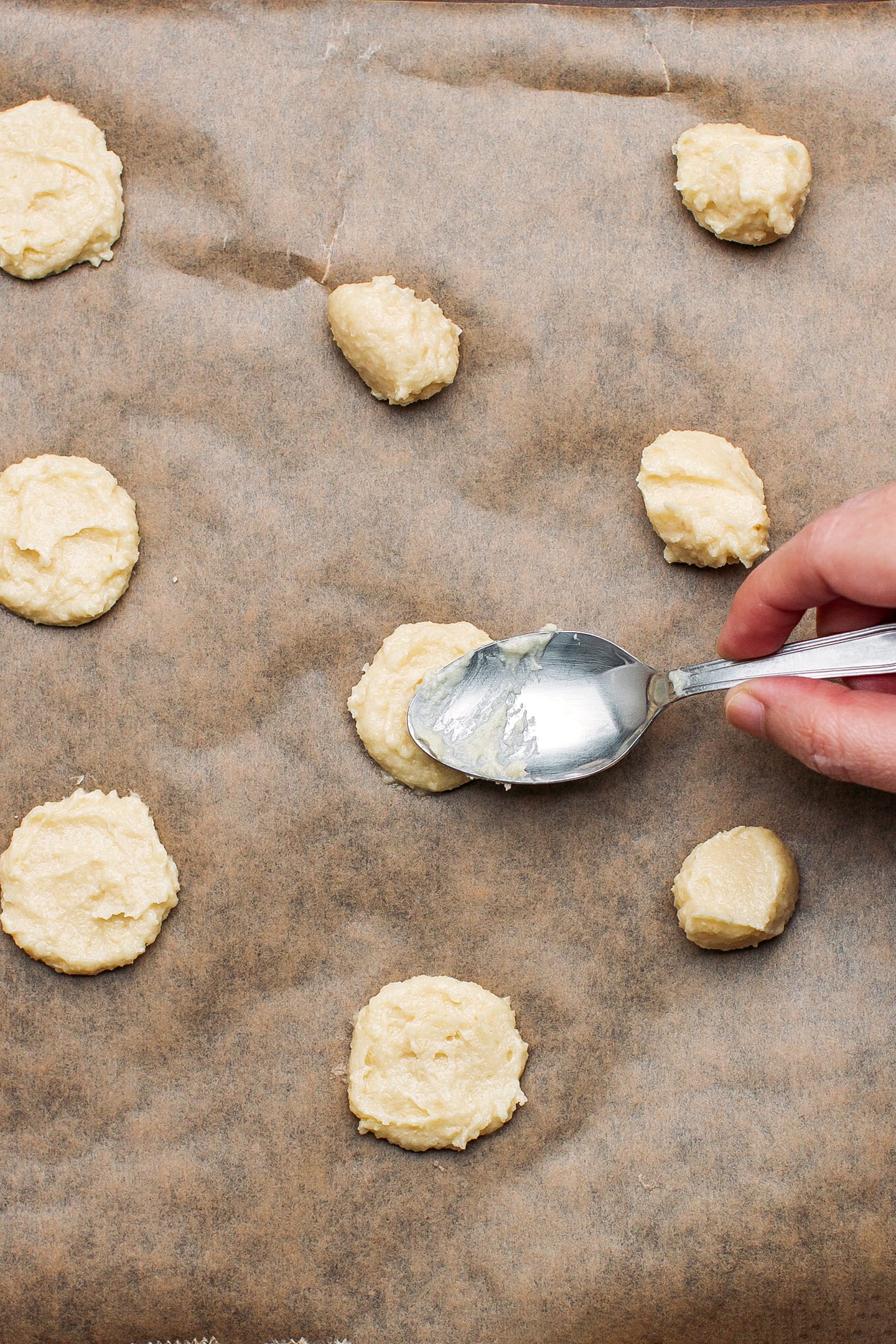 Top view of dollops of cookie dough on a baking sheet.