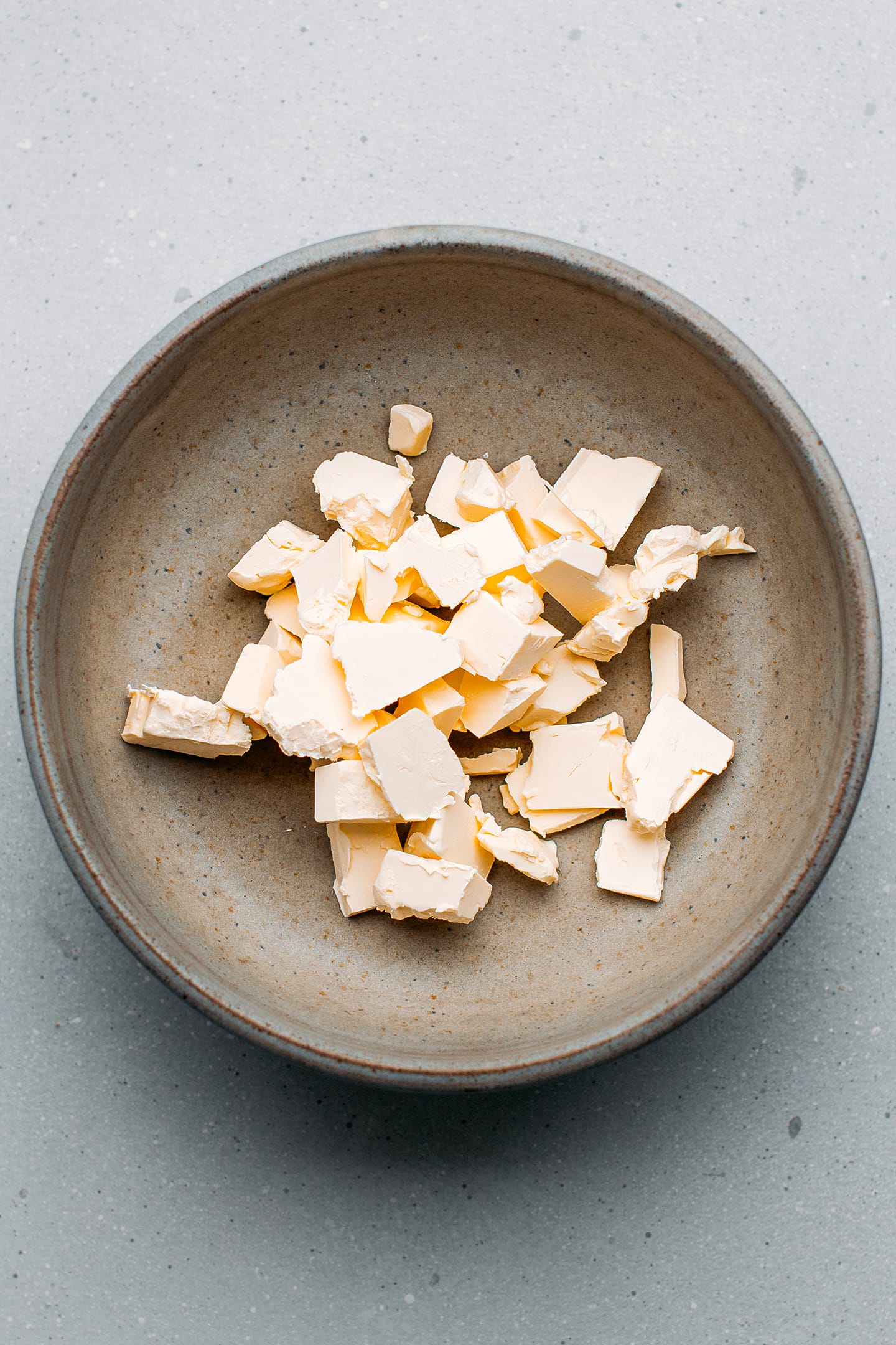 Diced butter in a mixing bowl.