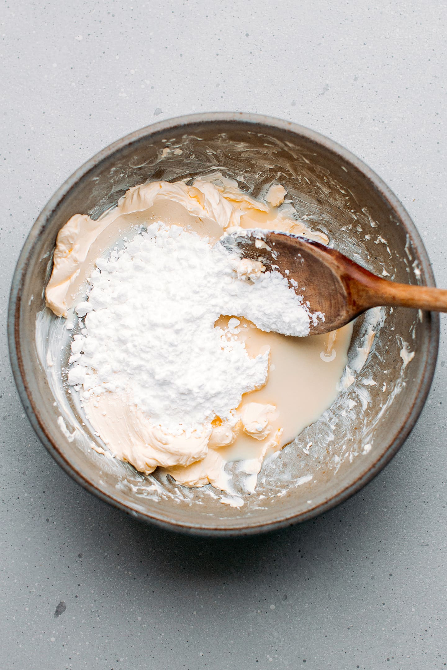 Creamed butter and powdered sugar in a mixing bowl.