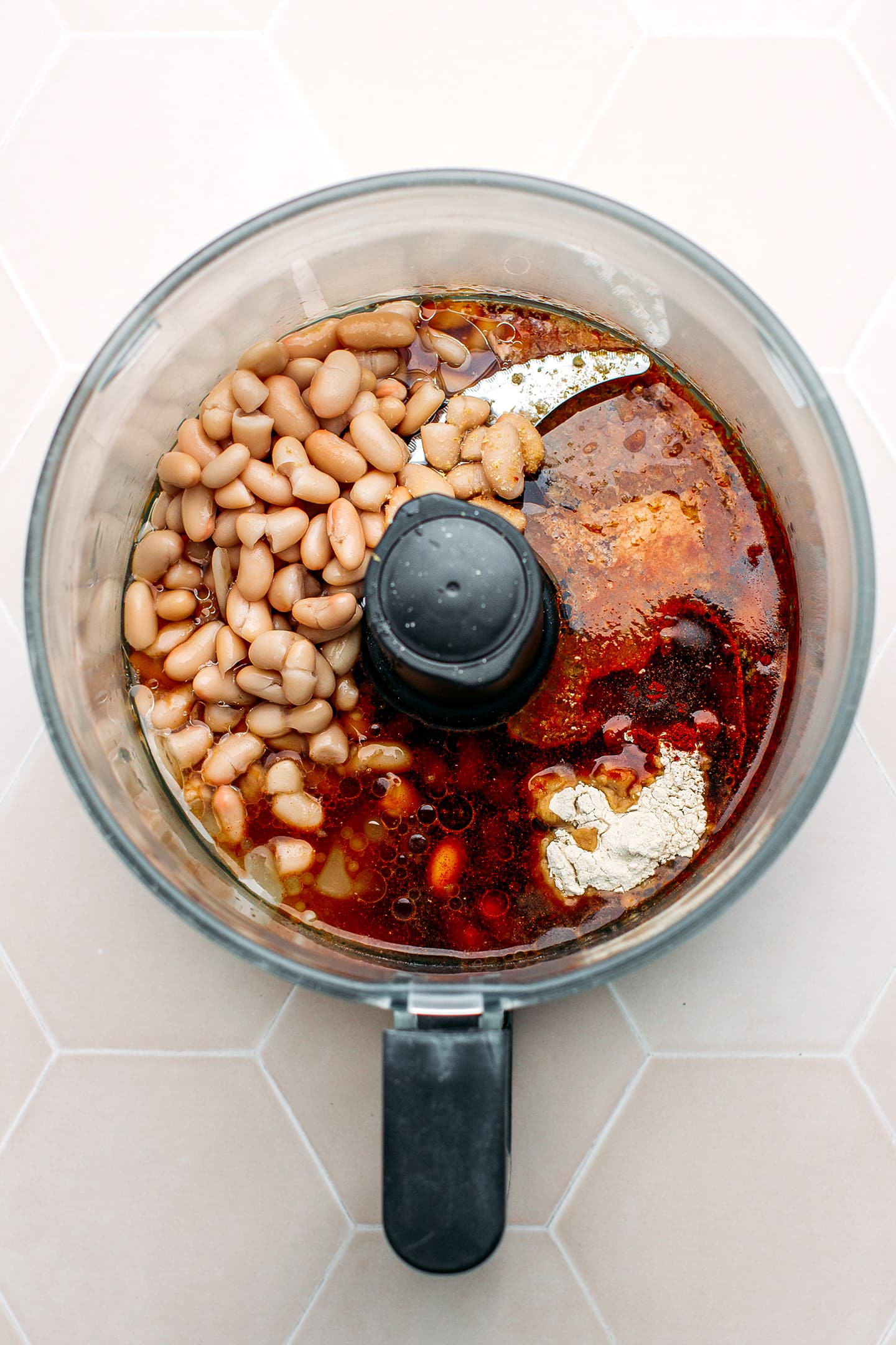 White beans, soy sauce, and onion powder in a food processor.