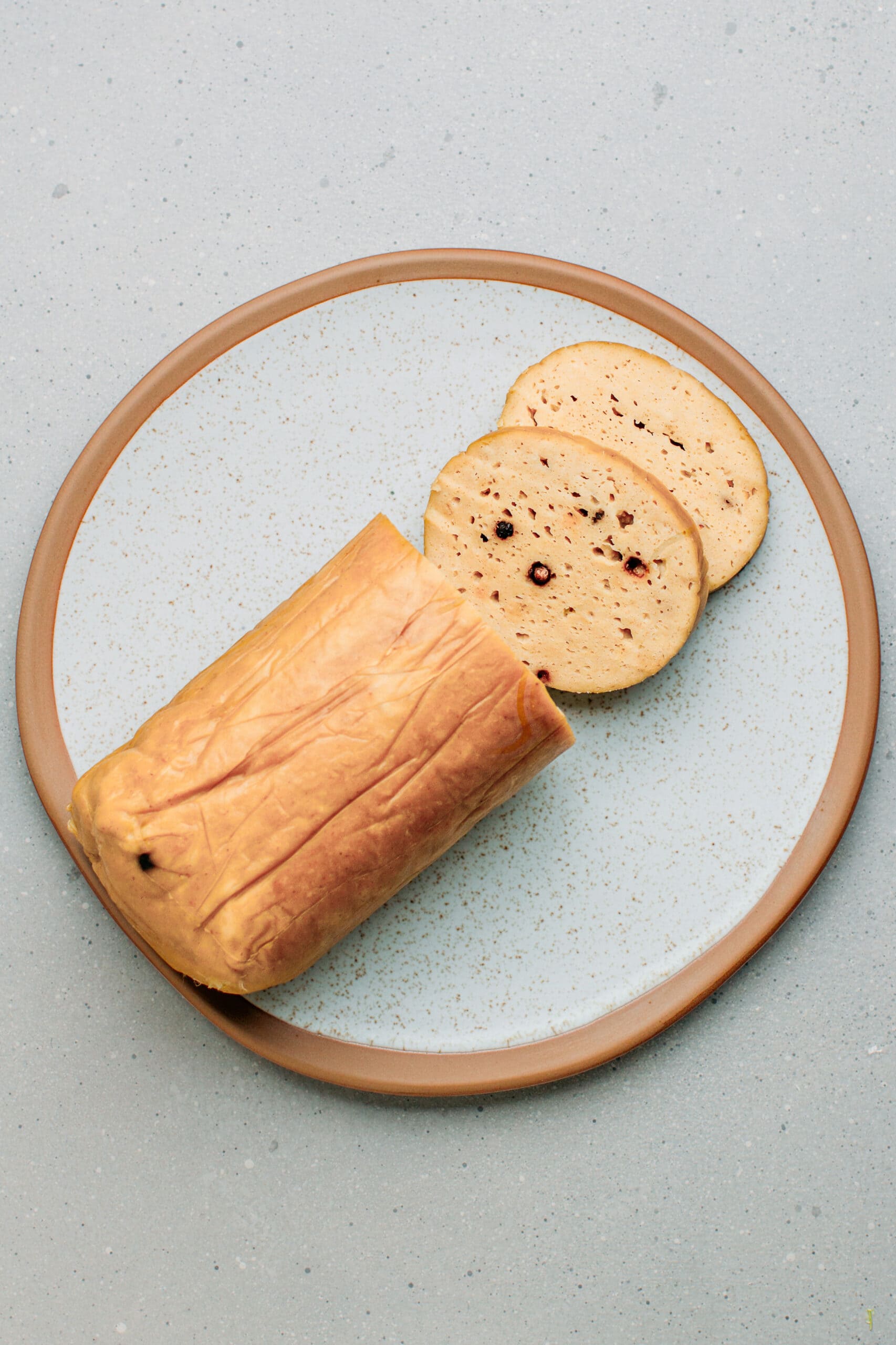 Sliced vegan baloney on a plate.