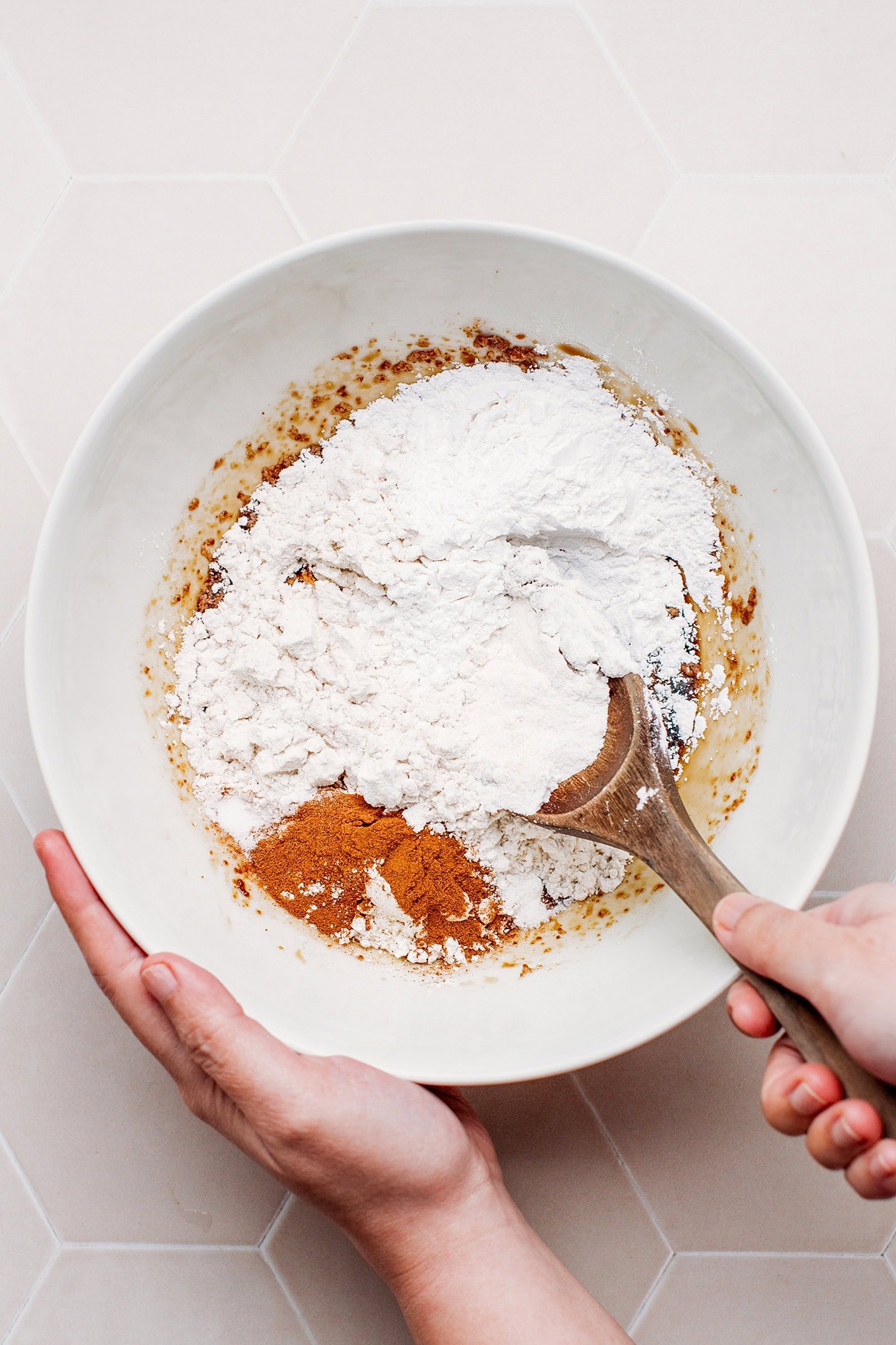 Mixing rice flour, coconut sugar, and coconut oil in a bowl.