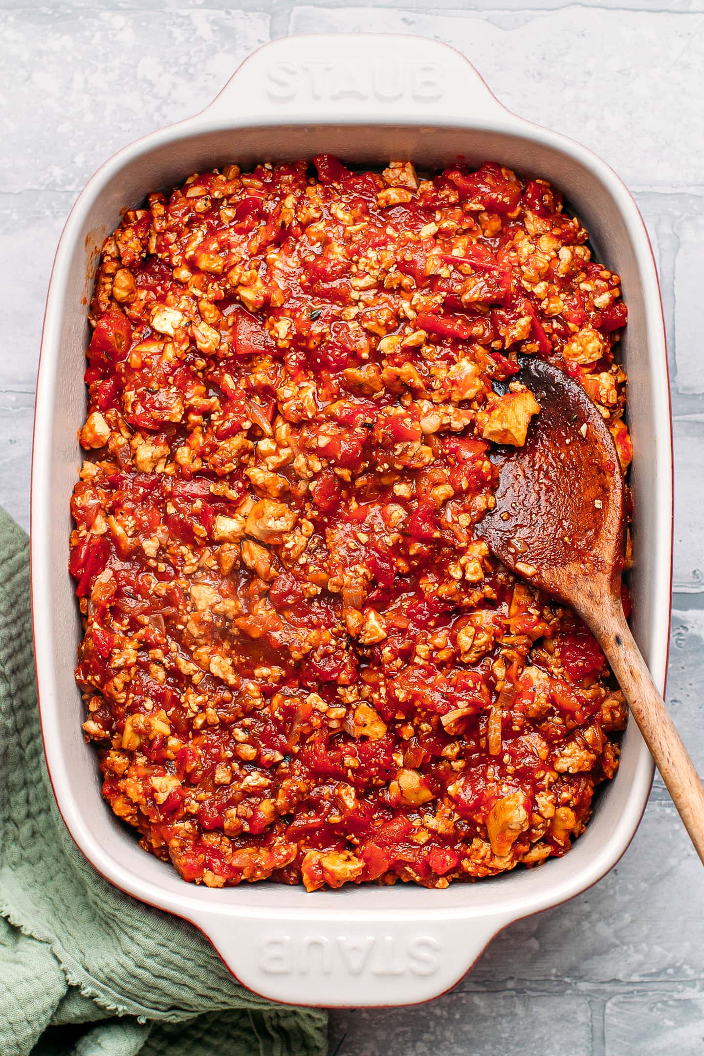 Tofu and tomato filling in a baking pan.