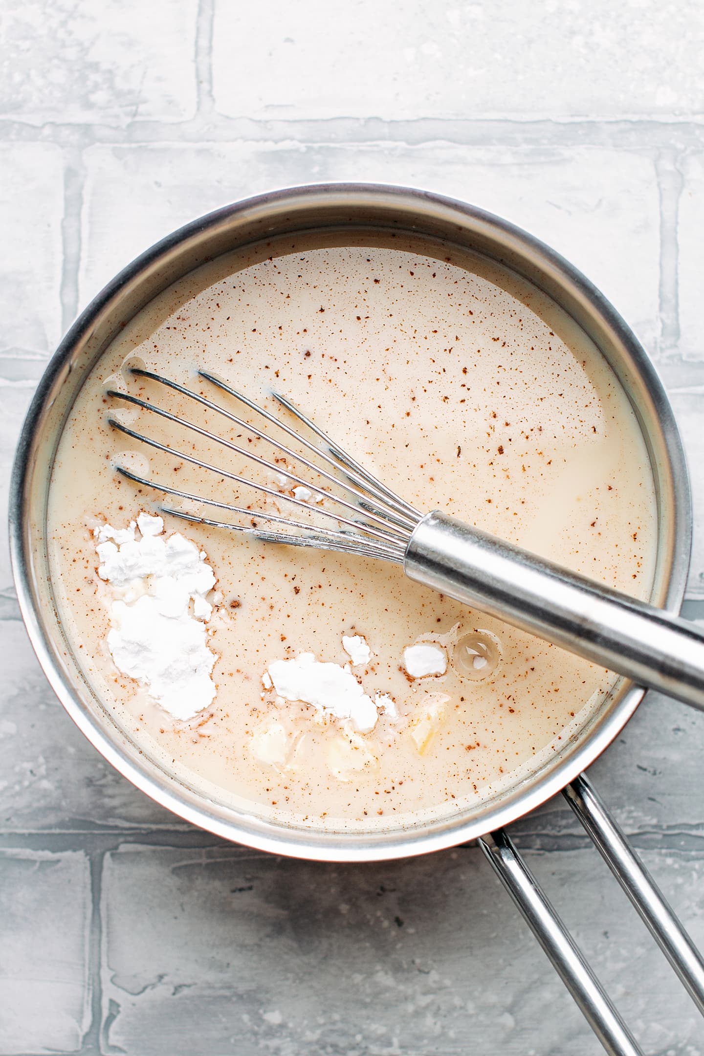 Almond milk and potato starch in a pan.