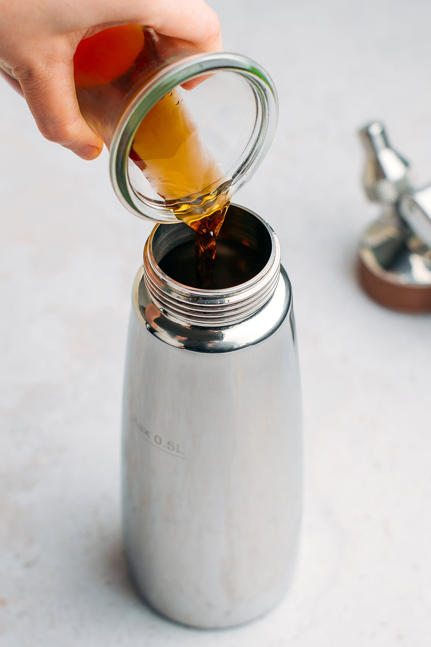 Pouring cold brew into a nitro dispenser.