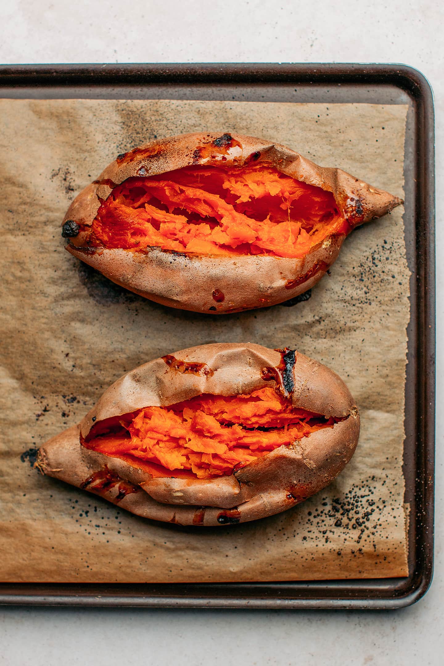 Baked sweet potatoes on a baking sheet.