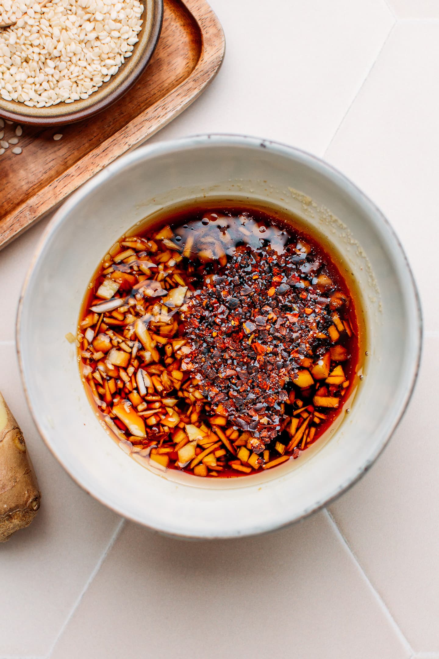 Soy sauce, rice vinegar, garlic, and ginger in a small bowl.