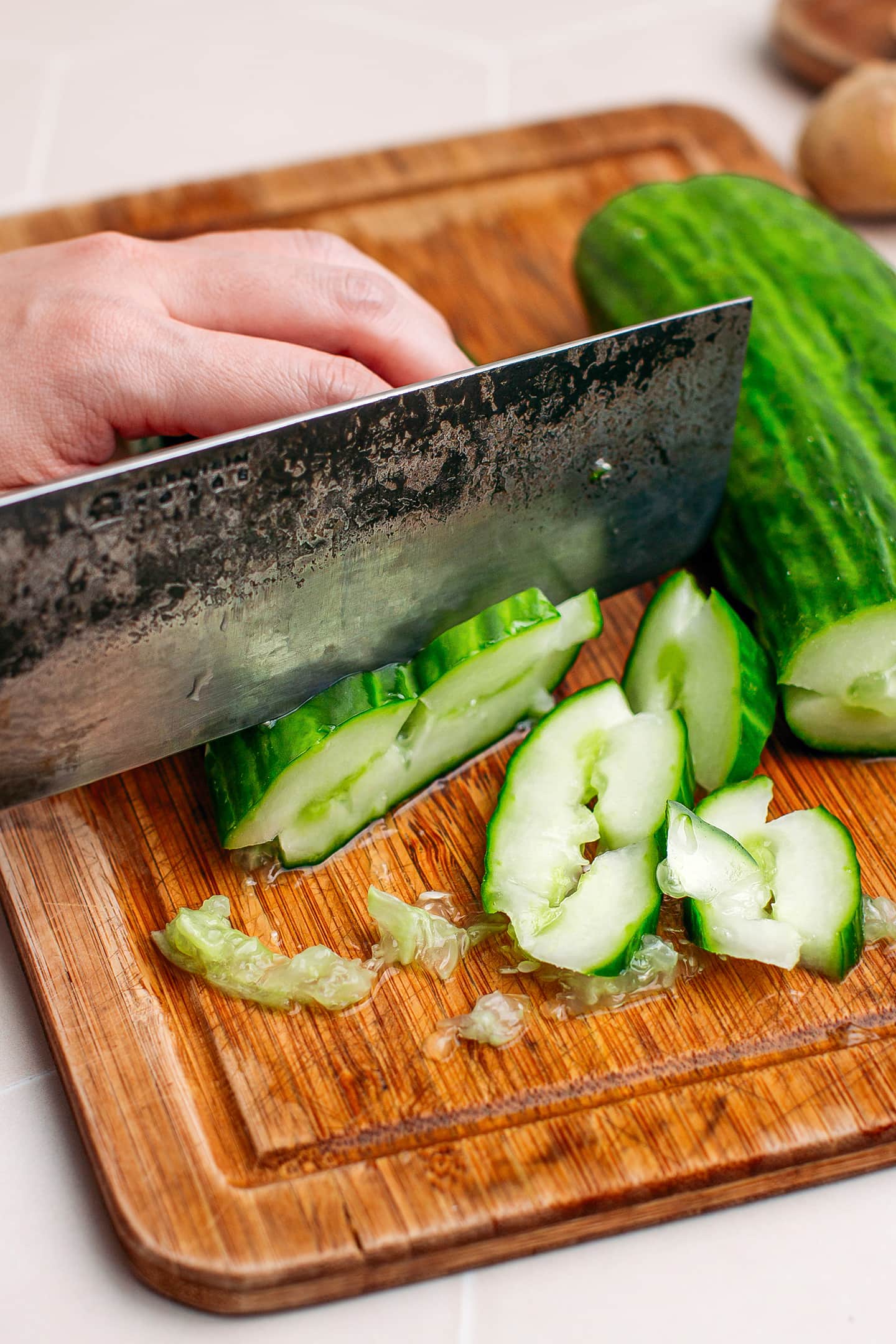 Slicing cucumbers on a cutting board.