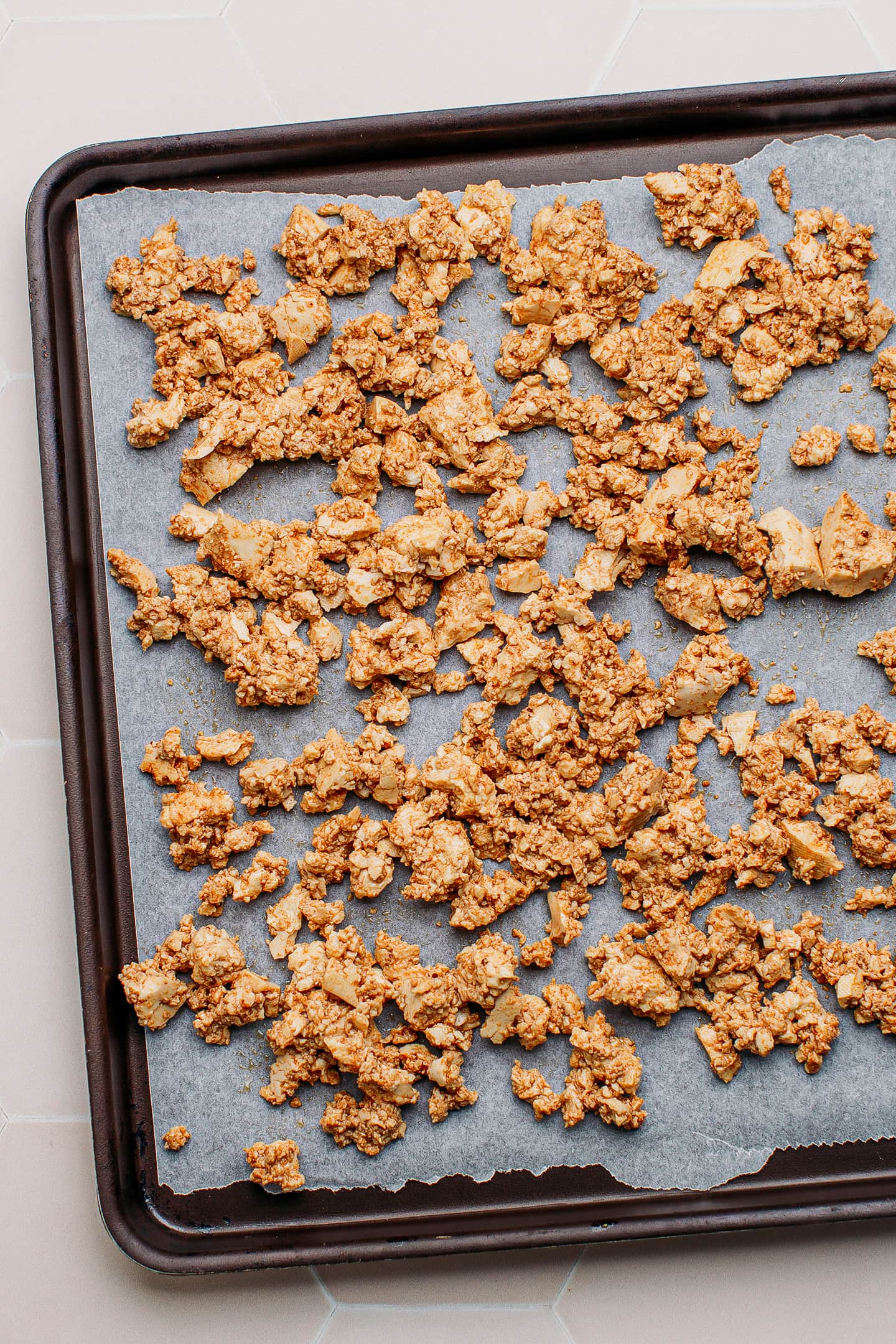 Scrambled tofu on a baking sheet.