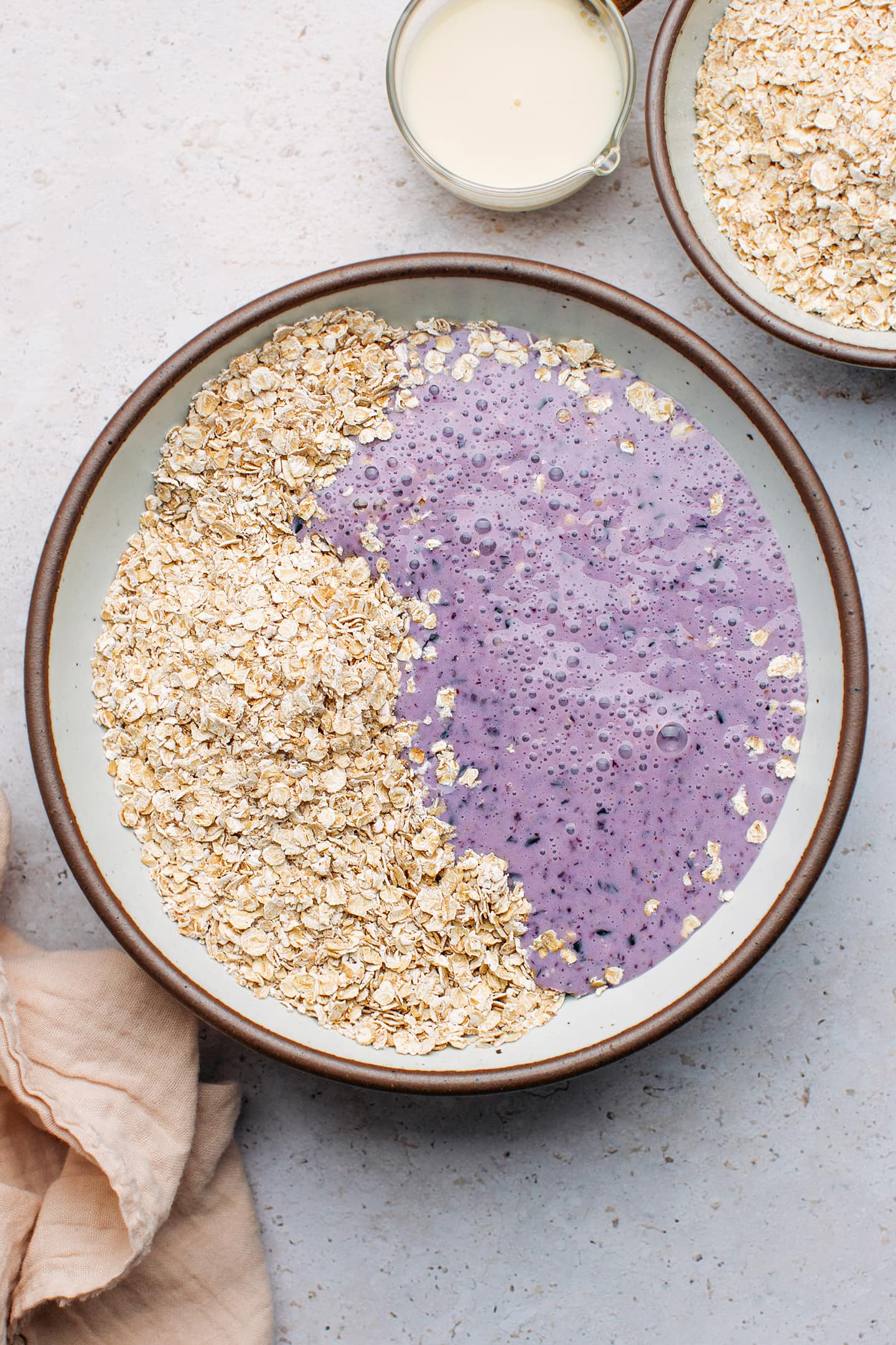 Blended blueberries and oats in a mixing bowl.