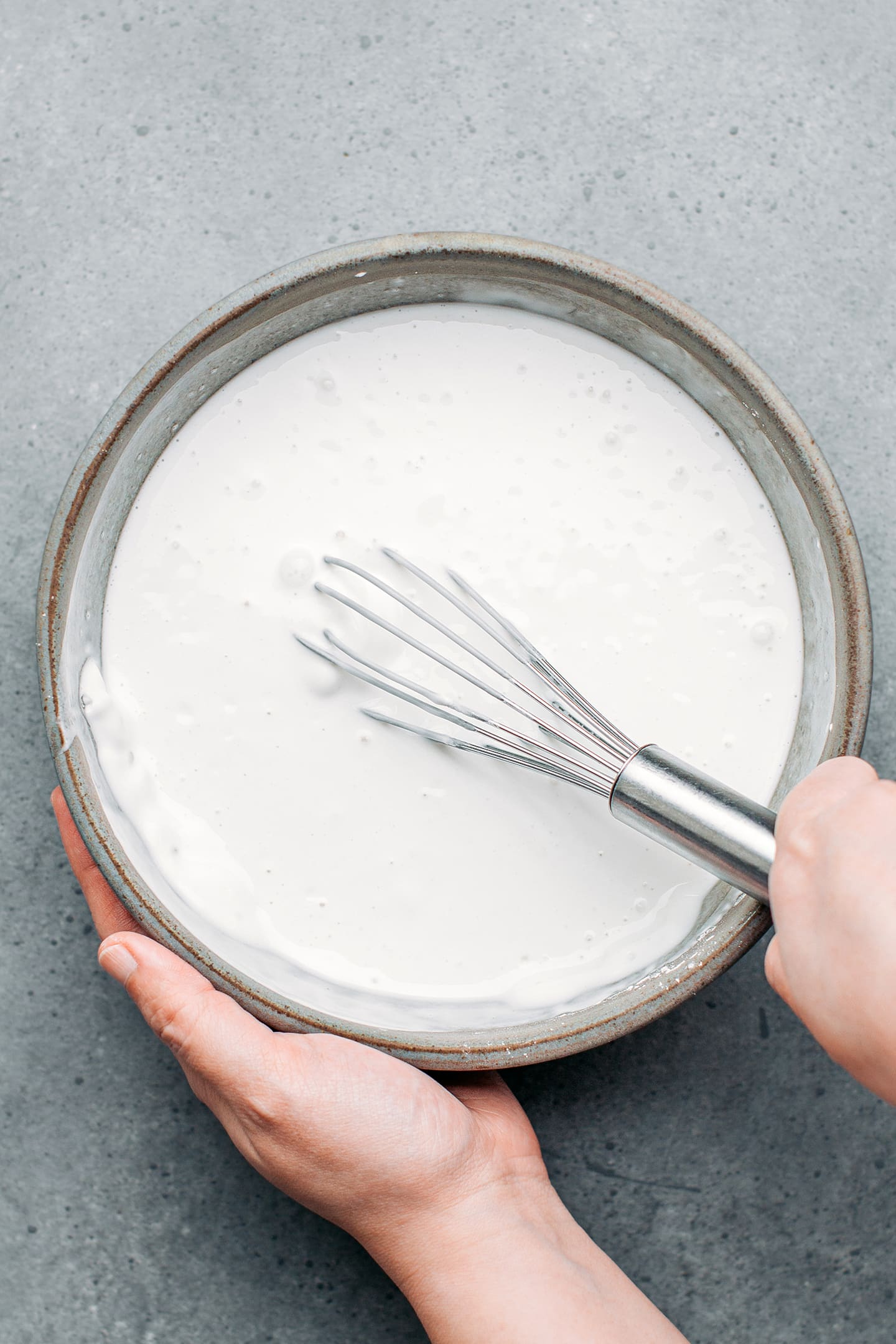 Whisking rice flour and water in a mixing bowl.