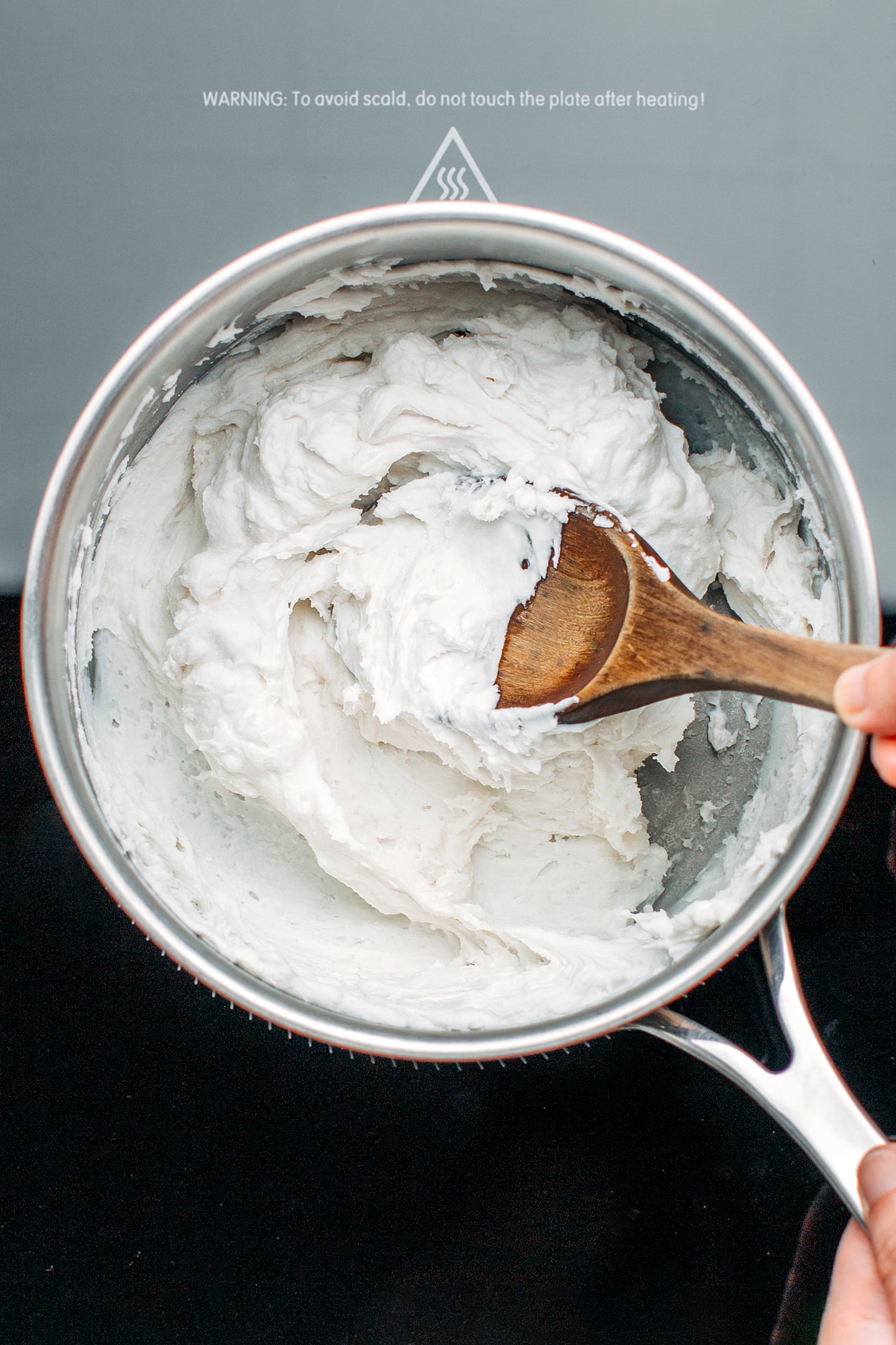 Stirring rice flour paste in a saucepan.