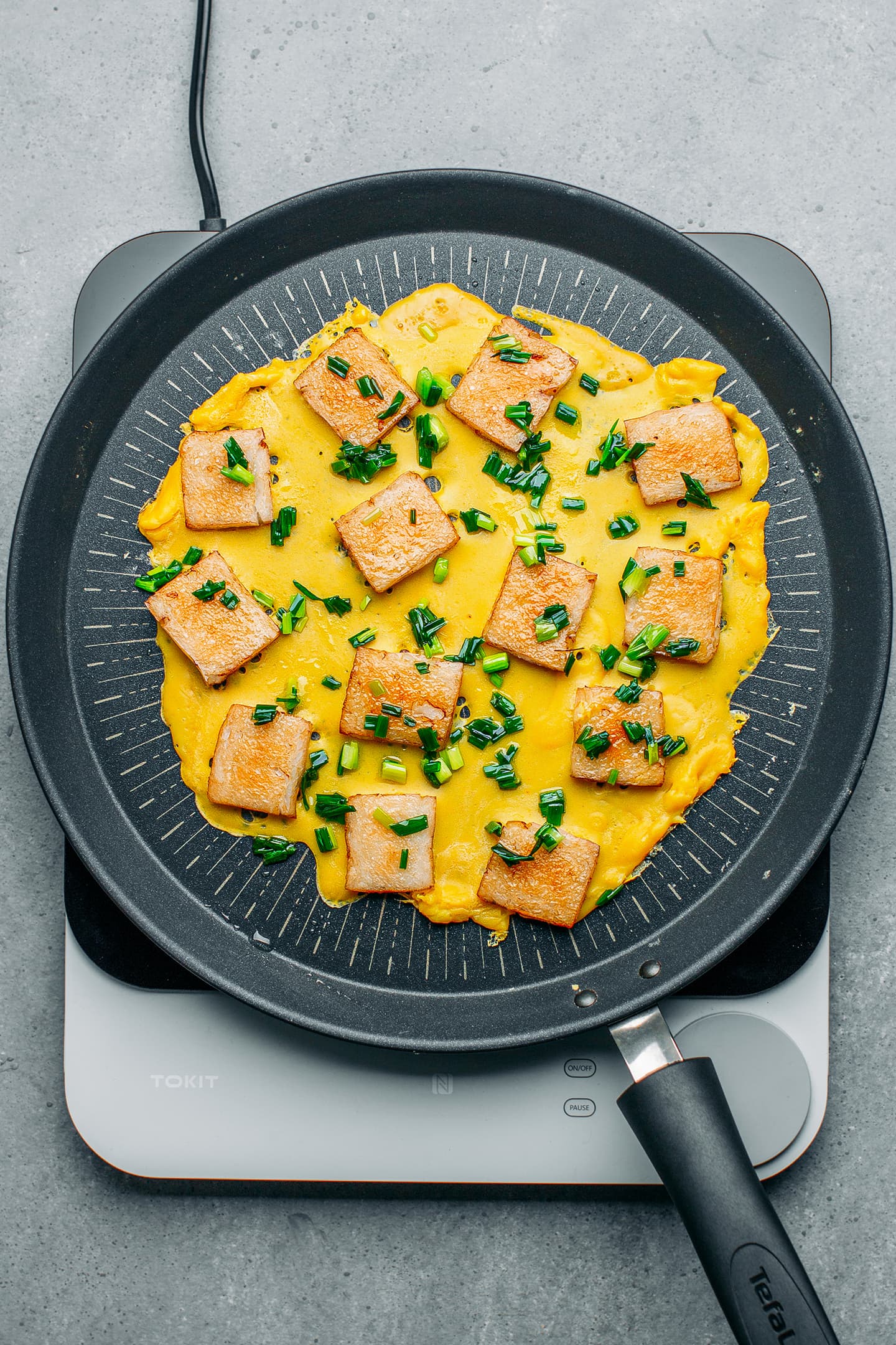 Rice cakes and vegan egg in a skillet.