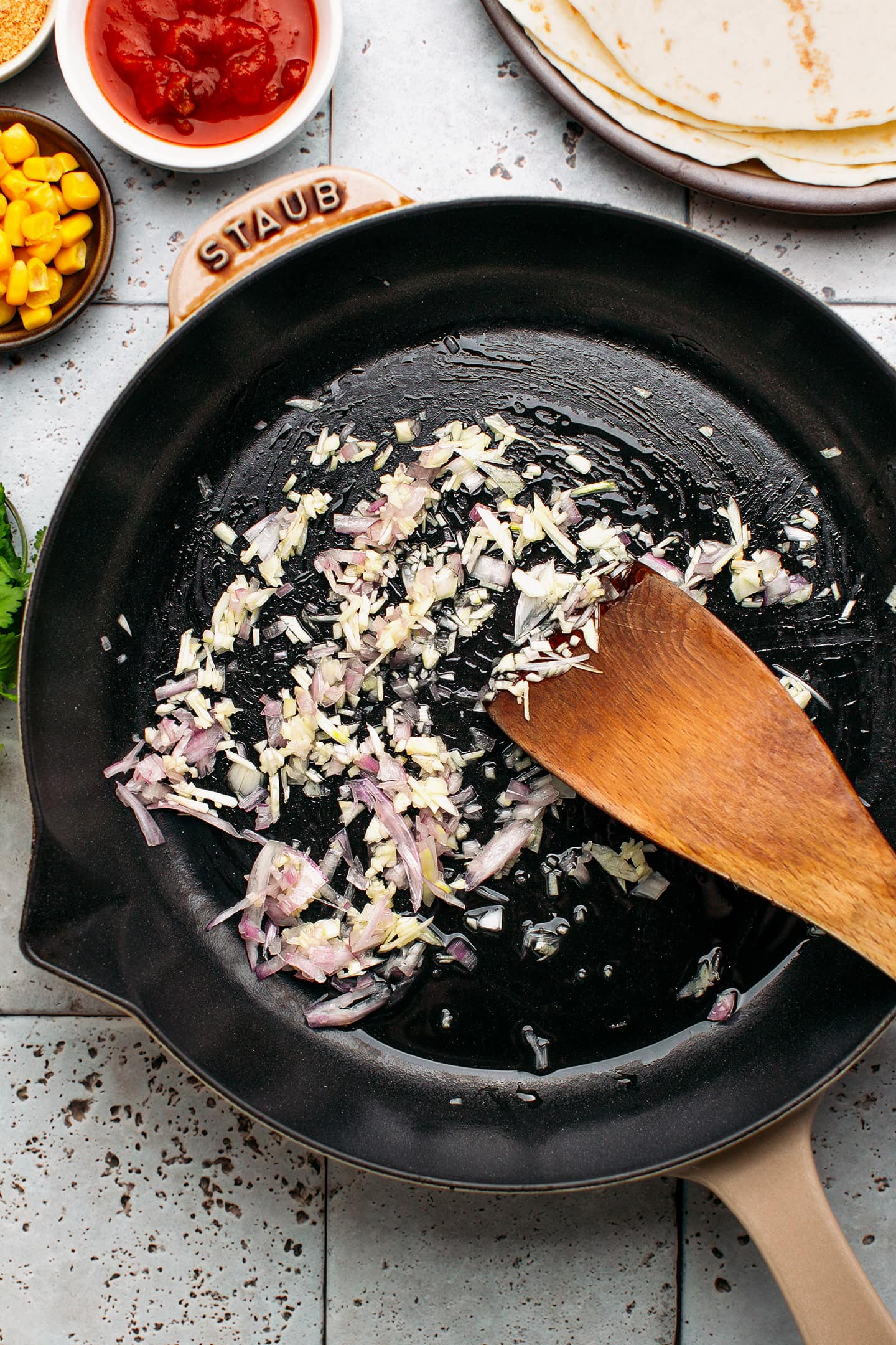 Sautéed garlic and shallots in a skillet.