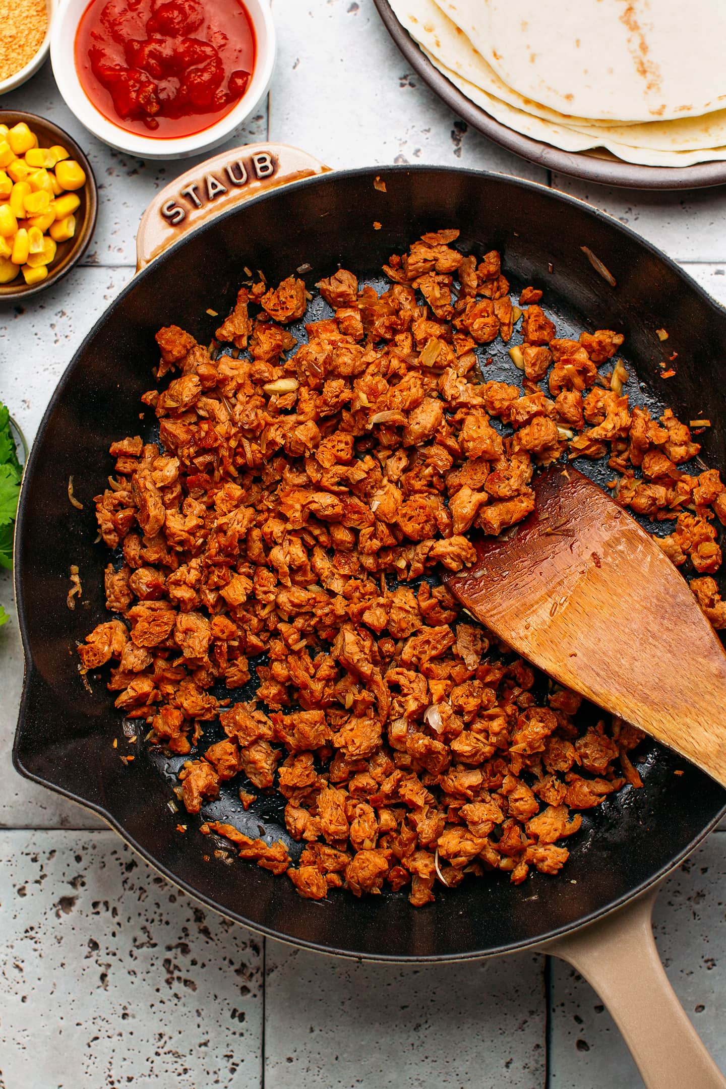 Sautéed soy curls in a skillet.