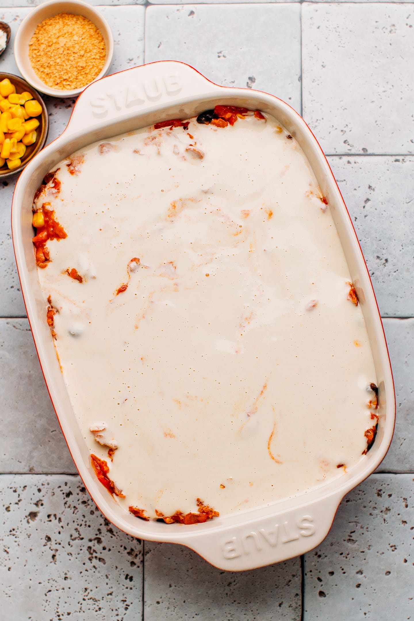 Enchilada casserole topped with cashew cheese sauce.