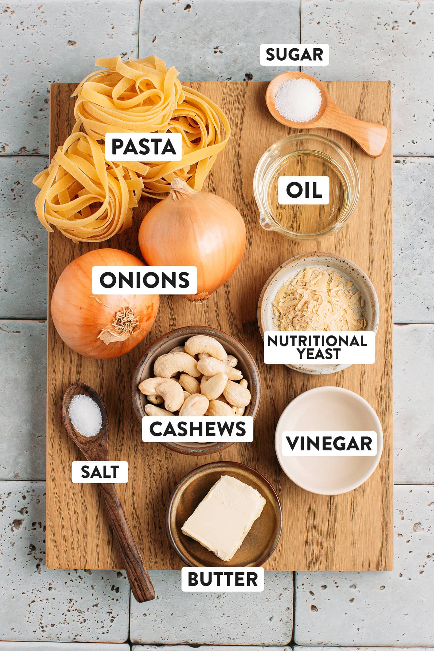 Ingredients like onions, pasta, cashews, oil, and butter.