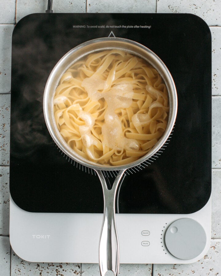 Pasta cooking in a pot of water.