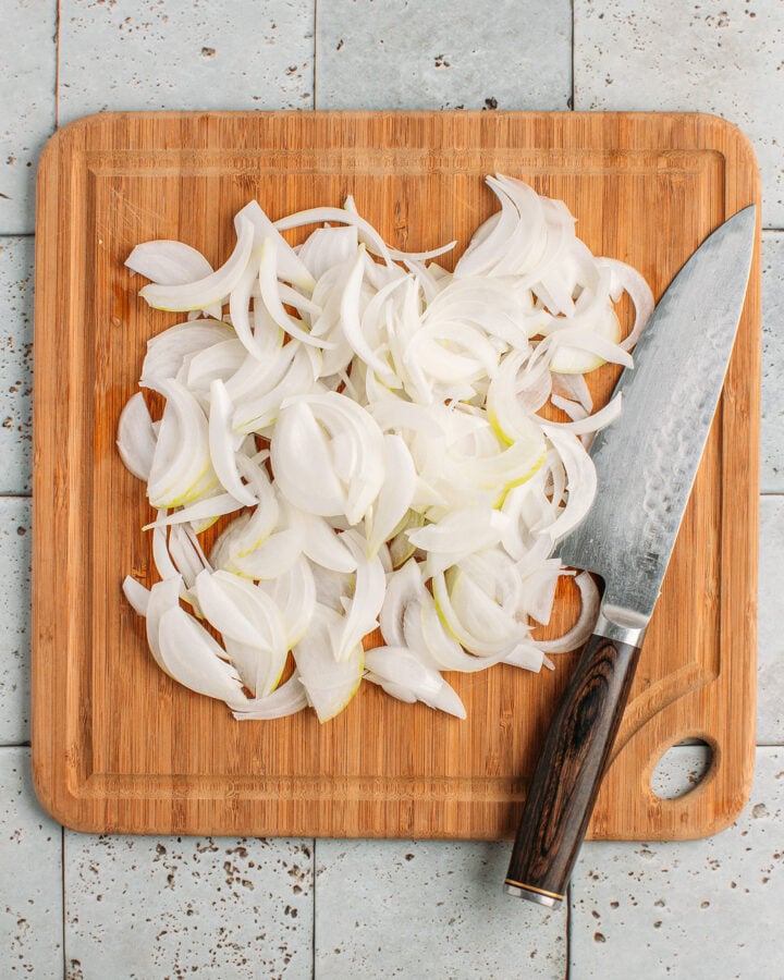 Sliced onions on a cutting board.