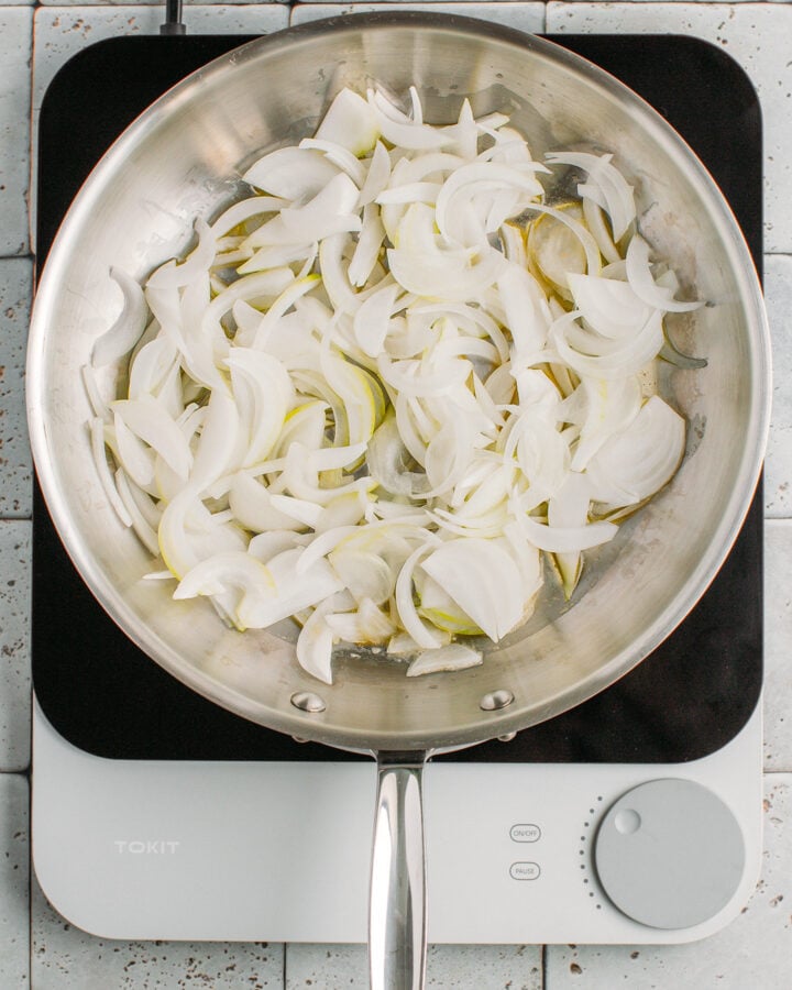 Sliced onions and butter in a skillet.