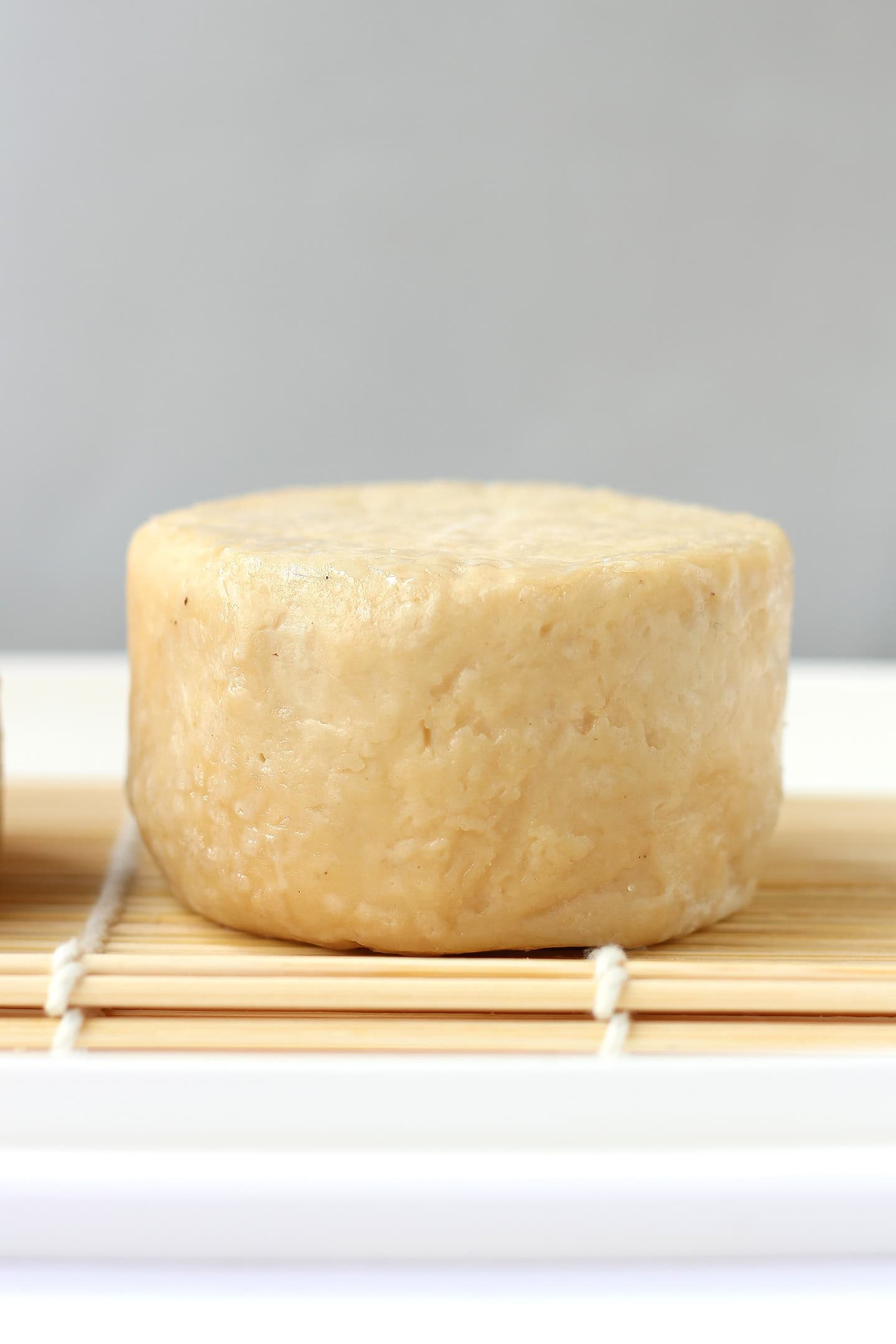 Aged cashew cheese on a bamboo mat.