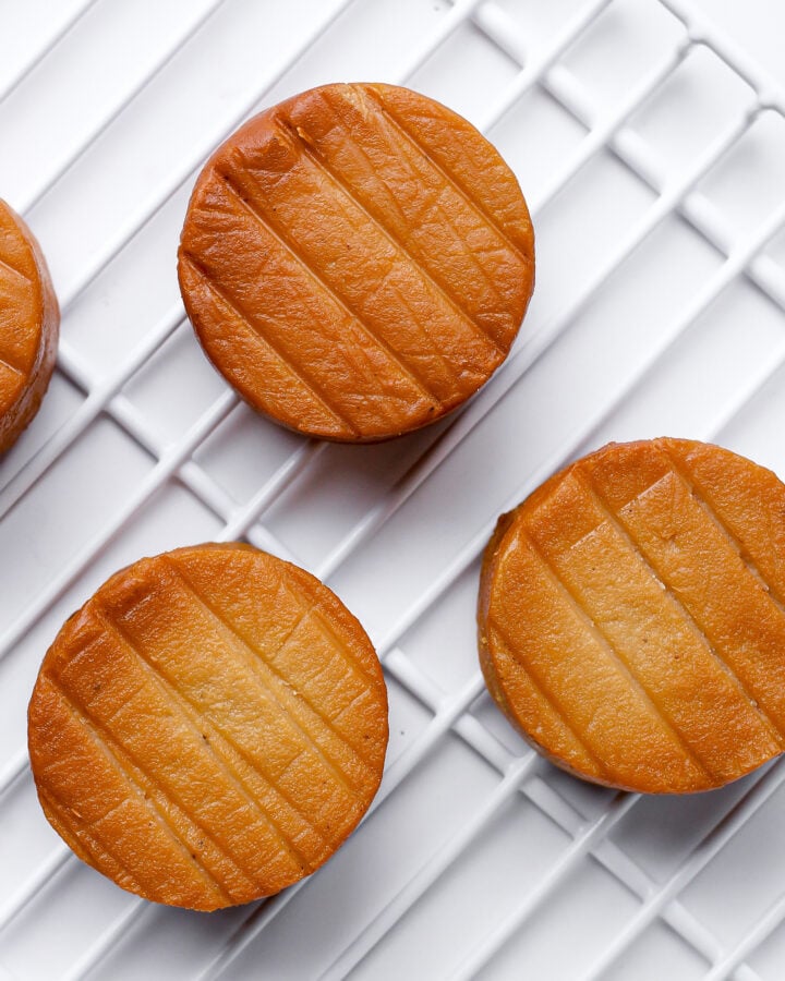 Smoked cashew cheeses on a grid.