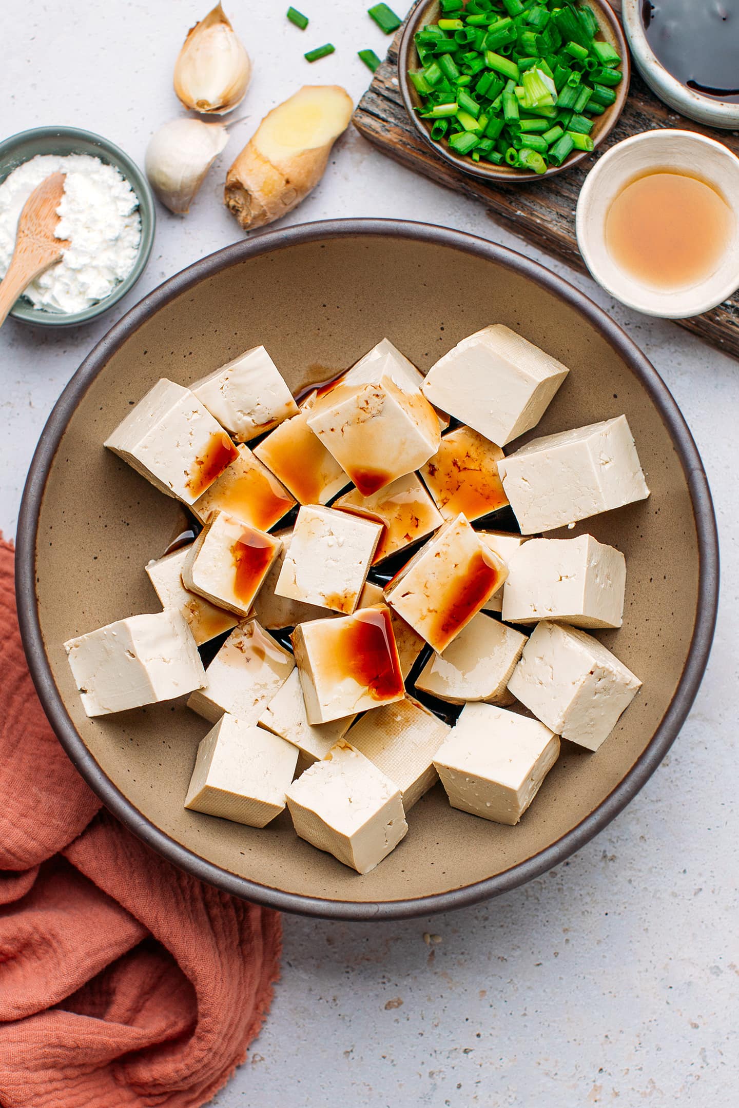 Diced tofu and soy sauce in a bowl.