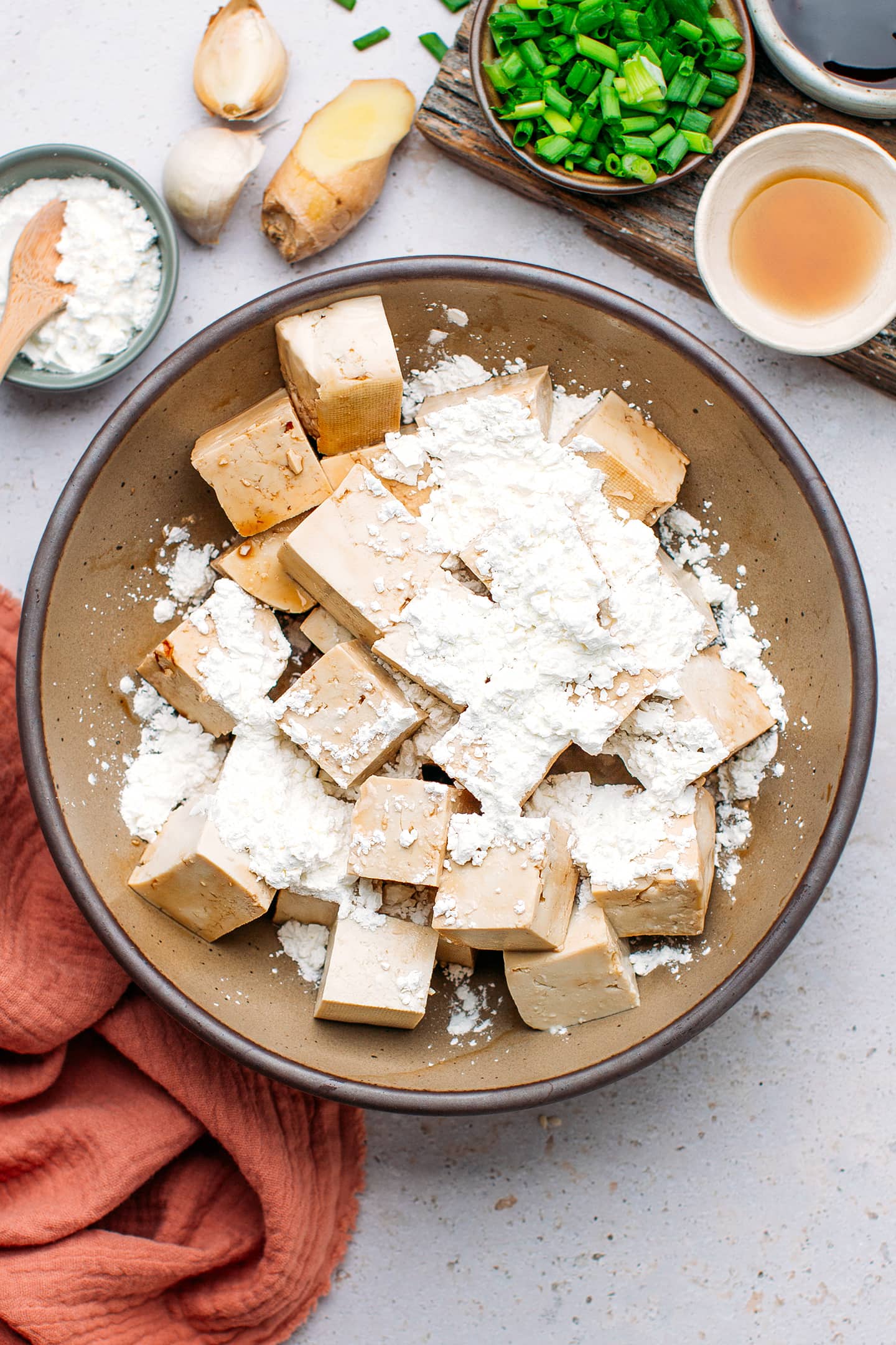 Diced tofu and cornstarch in a bowl.