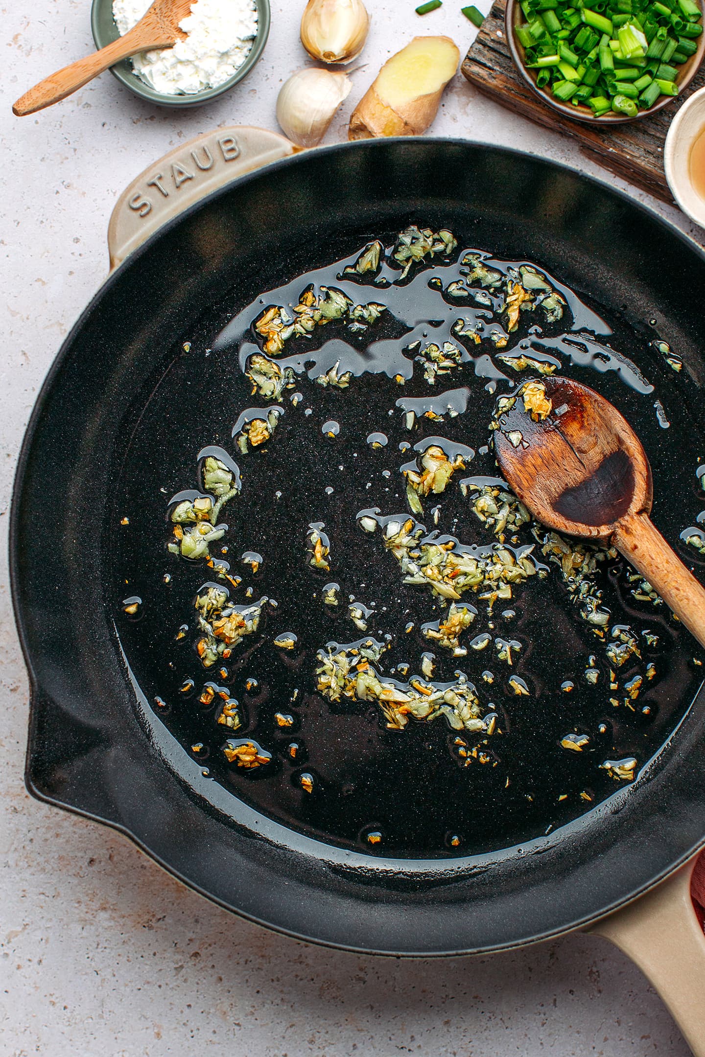 Minced garlic and ginger in a skillet.