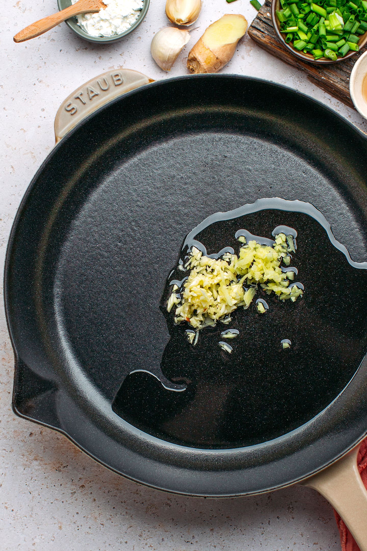 Sautéed garlic and ginger in a skillet.