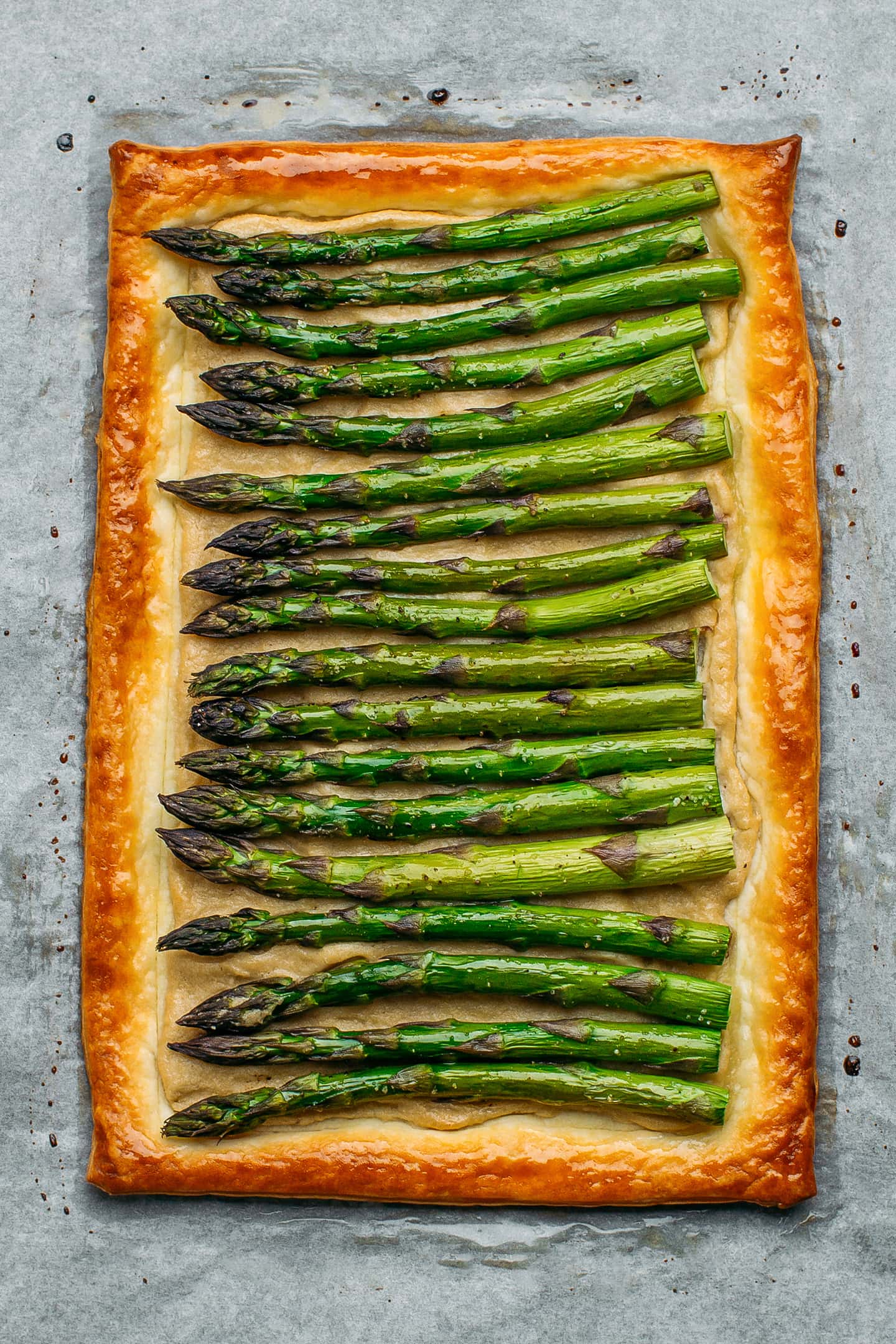 Baked asparagus tart on a baking sheet.