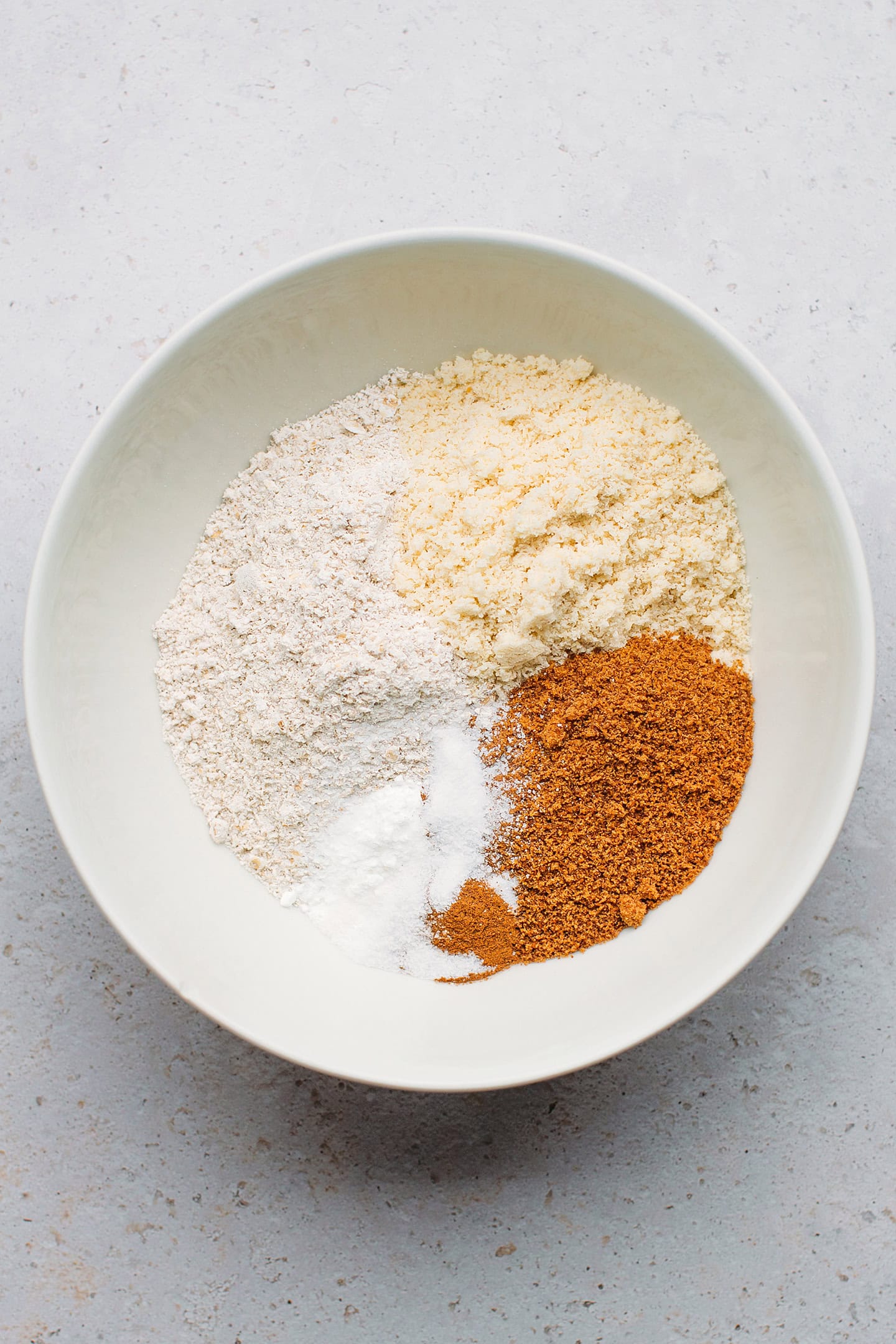 Oat flour, almond flour, and coconut sugar in a mixing bowl.