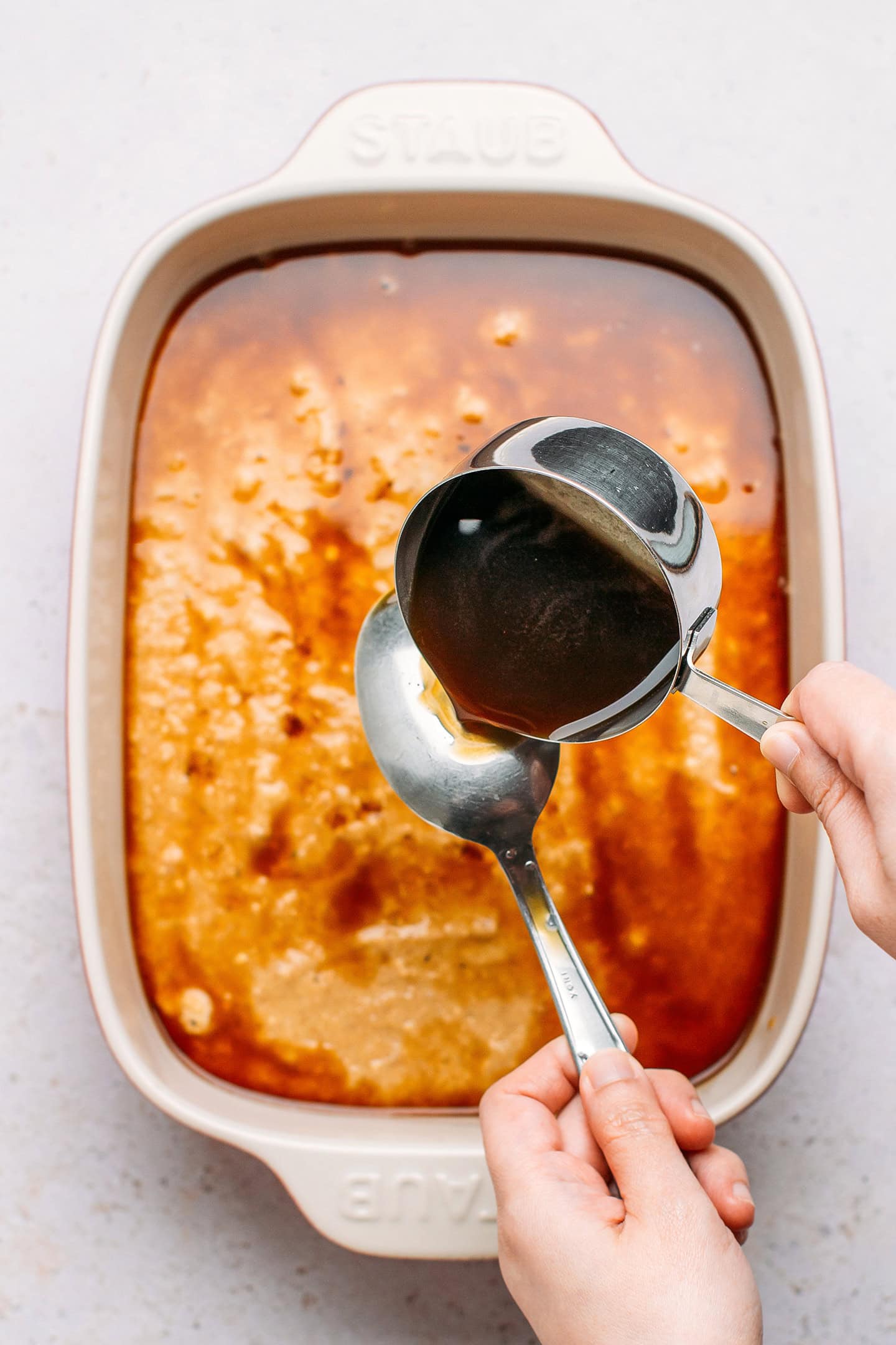 Pouring sweet sauce over the back of a spoon.